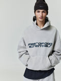 Front view of light gray Heavy Fleece 90s Hoodie with bold Fear of God Essentials logo worn with dark beanie 0008_HO25_F_L54_P31_2325.jpg