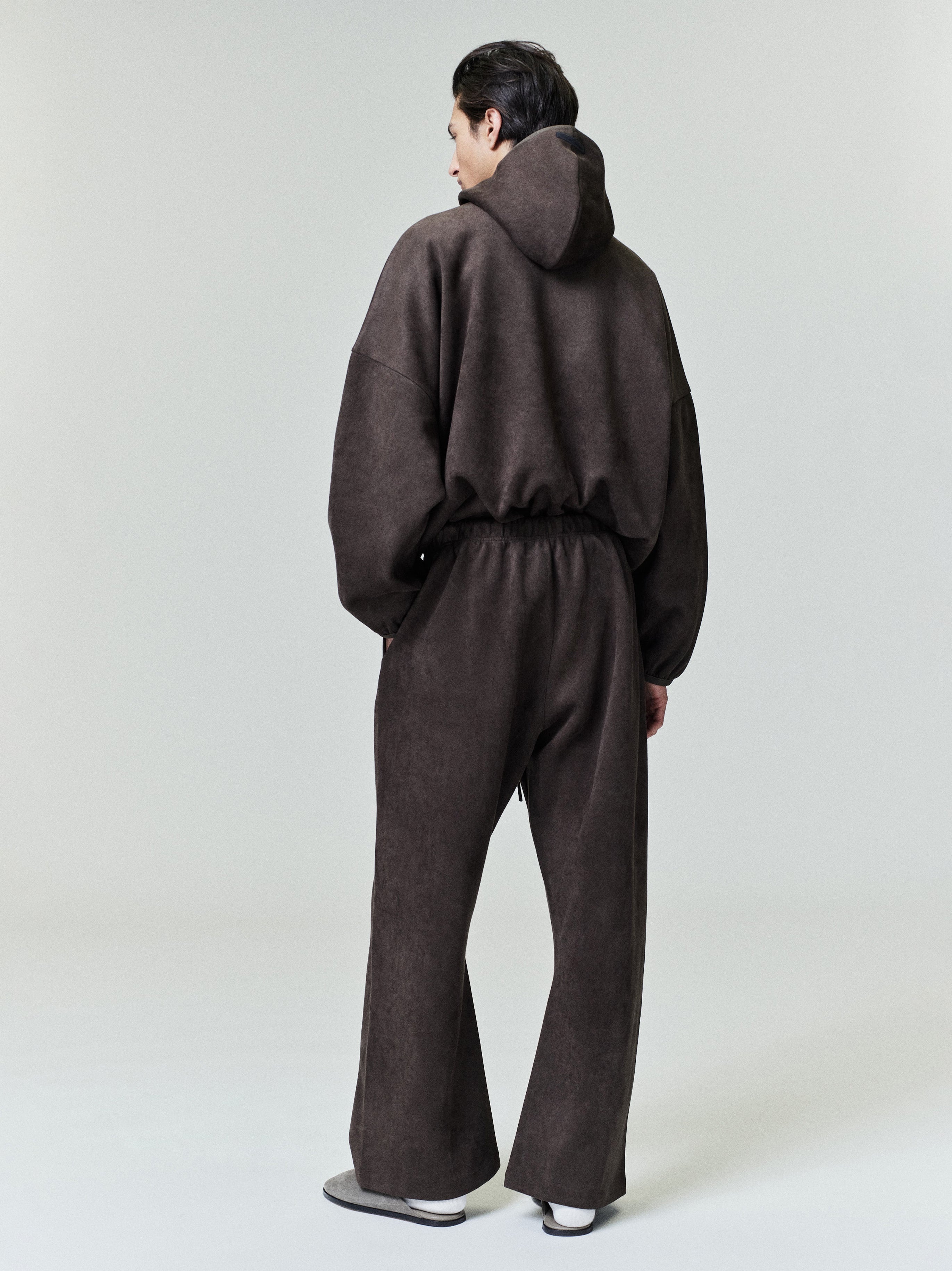 Back view of model wearing dark brown suede fleece modern hoodie with elasticated waist and matching pants, file 0023_HO25_F.jpg