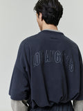 Rear view of man wearing oversized Los Angeles 90s Tee with large tonal numeric print on back neckline