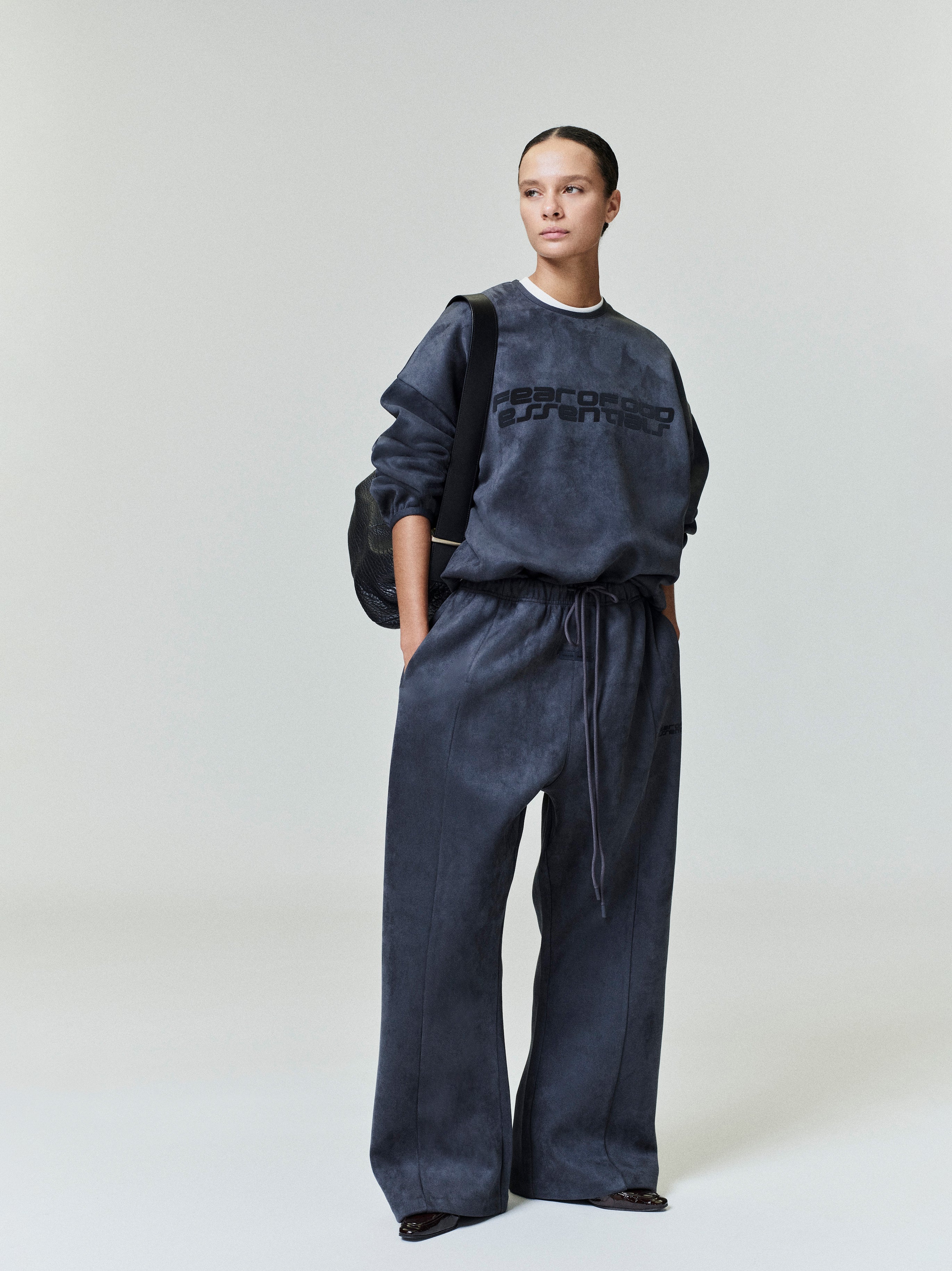 Full body shot of model wearing charcoal Suede Fleece Modern Crewneck Sweatshirt with matching relaxed pants 0044_HO25_FW_L37_0411.jpg