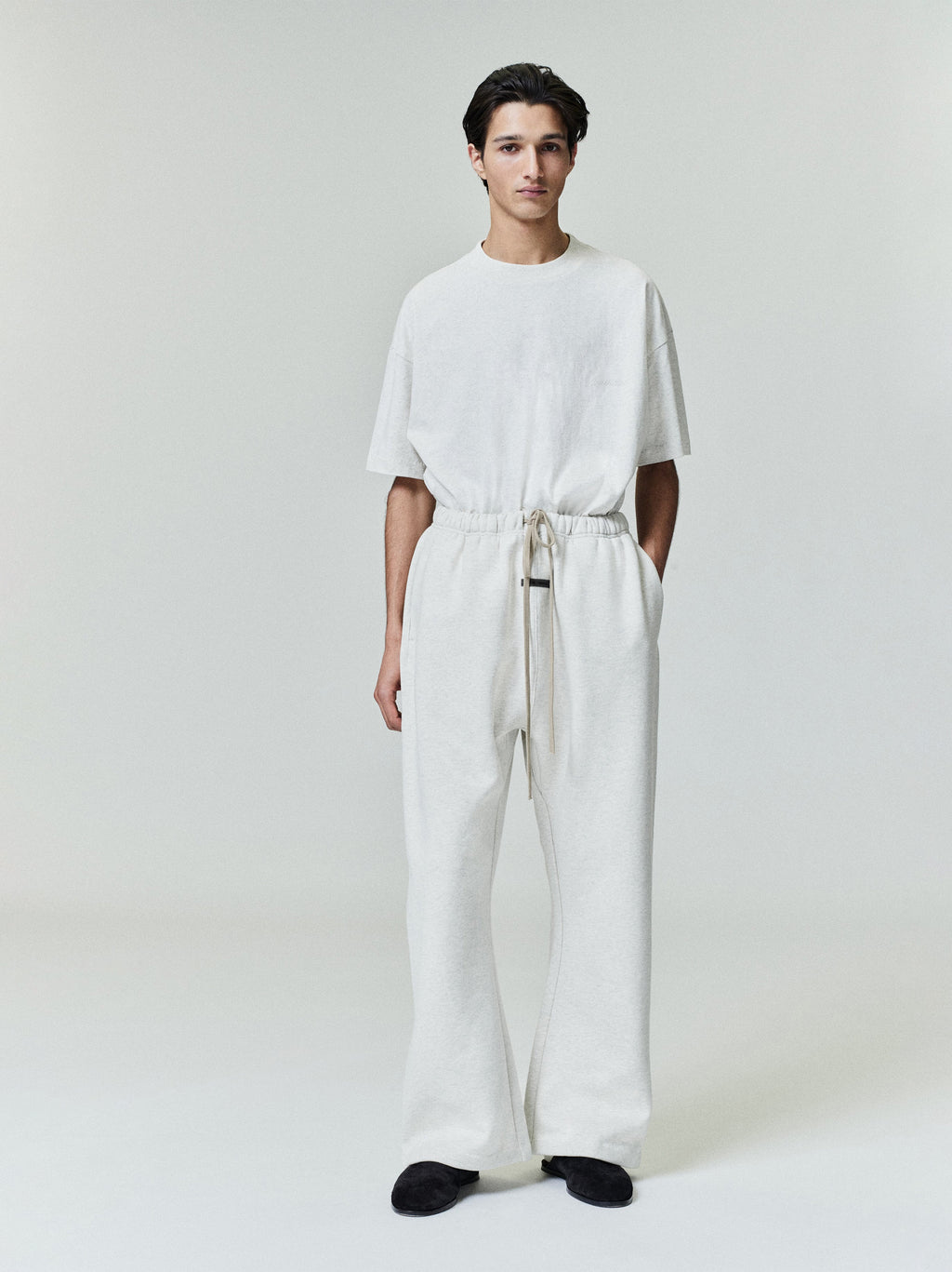 Male model in relaxed fit ivory Embroidered Essential Tee with matching wide-leg pants, full front view gallery image 0