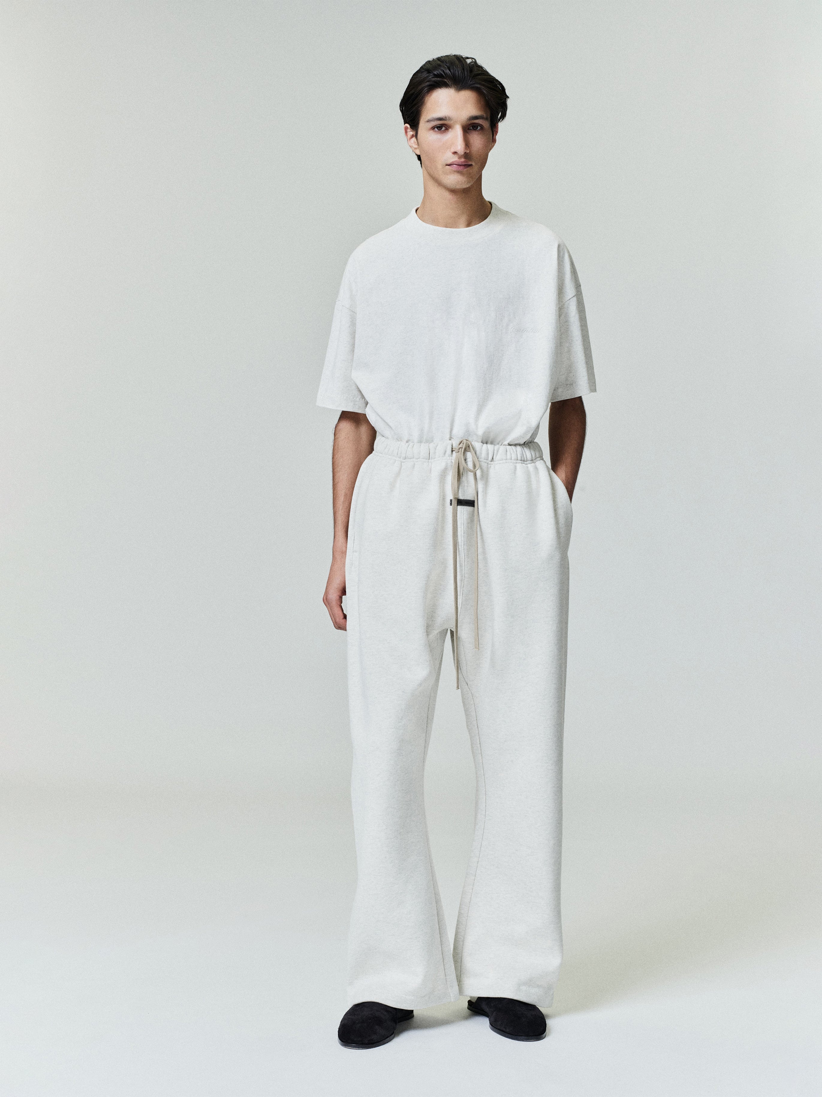Male model in relaxed fit ivory Embroidered Essential Tee with matching wide-leg pants, full front view gallery image 0