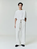 Male model wearing cream Flare Sweatpant with elastic waistband and long drawstrings, front view, gallery image 0