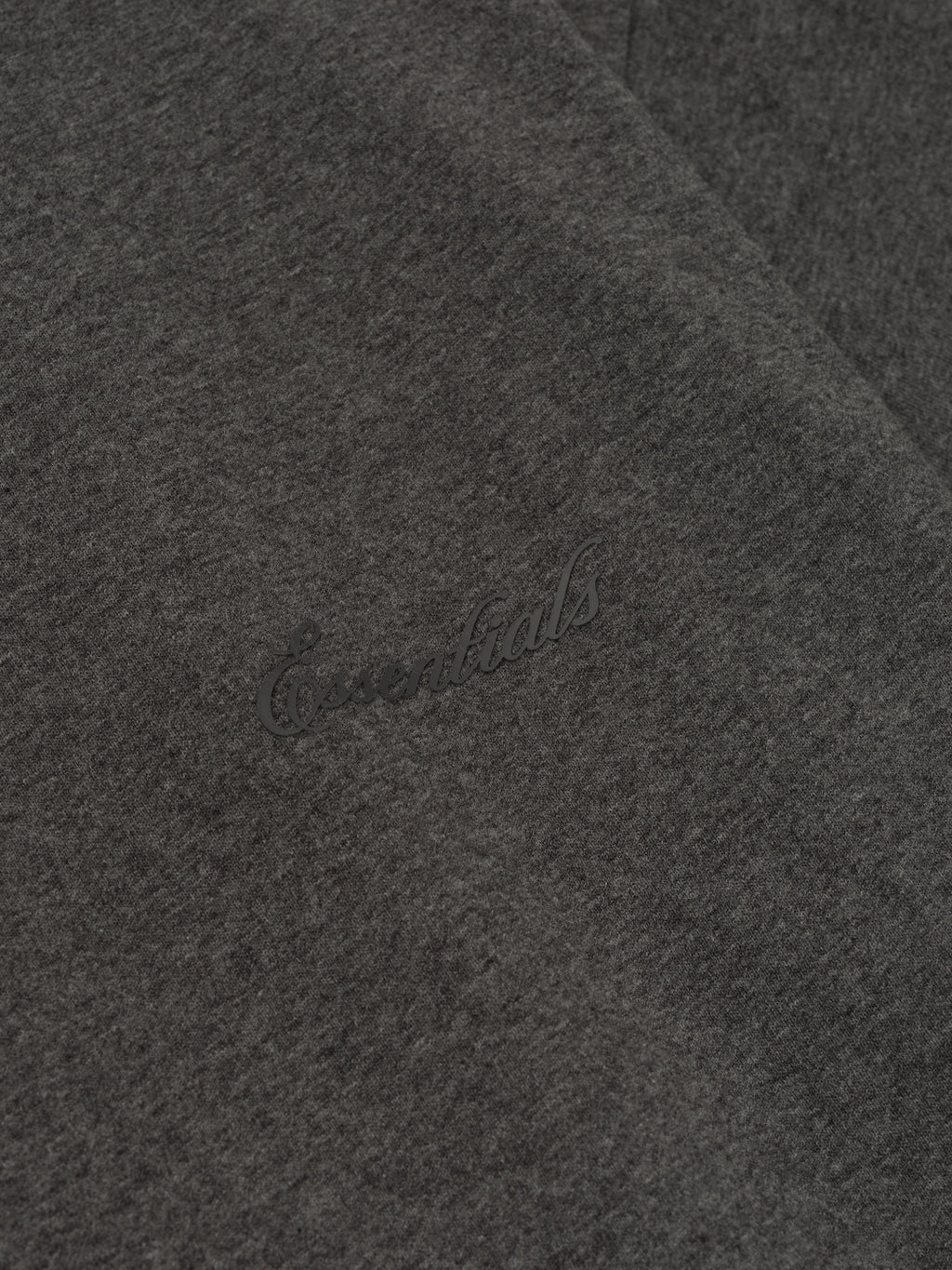 Close-up of charcoal heather Embroidered Classic Short Sleeve Tee showing subtle tonal Essentials logo on soft fabric