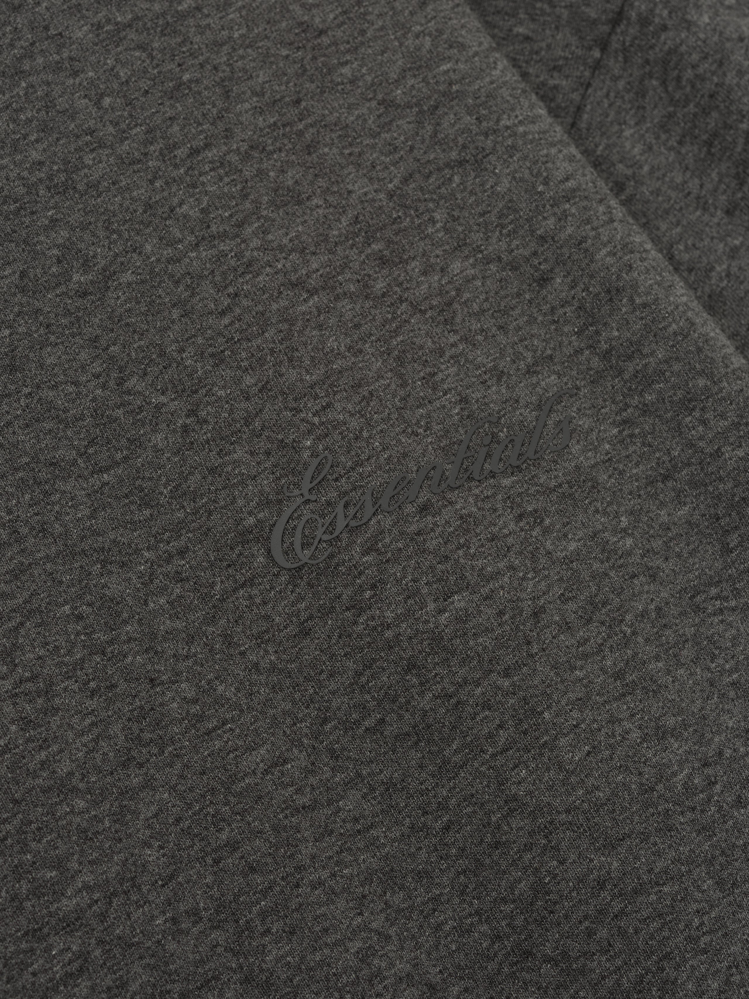 Close-up of charcoal heather Embroidered Classic Fit Long Sleeve showing tonal Essentials logo detail, gallery image 0