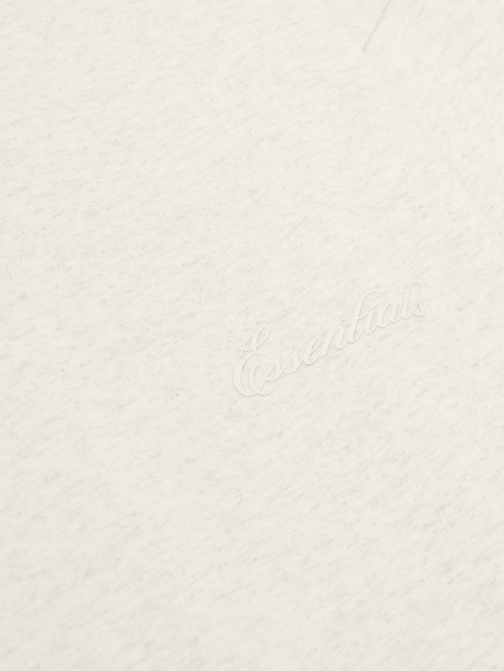 Close-up of oatmeal heather Embroidered Classic Long Sleeve Tee showing tonal Essentials logo detail, gallery image 0