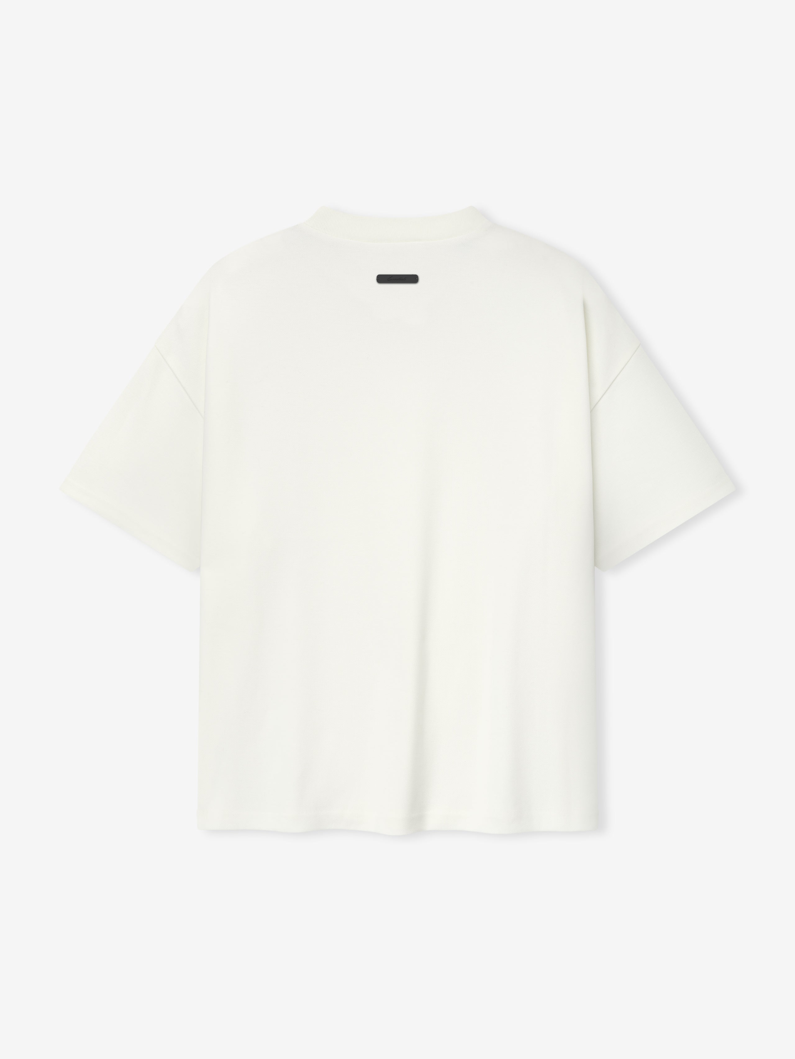 back view of white medium-weight cotton poly pique tee with oversized 90s fit and dropped shoulders