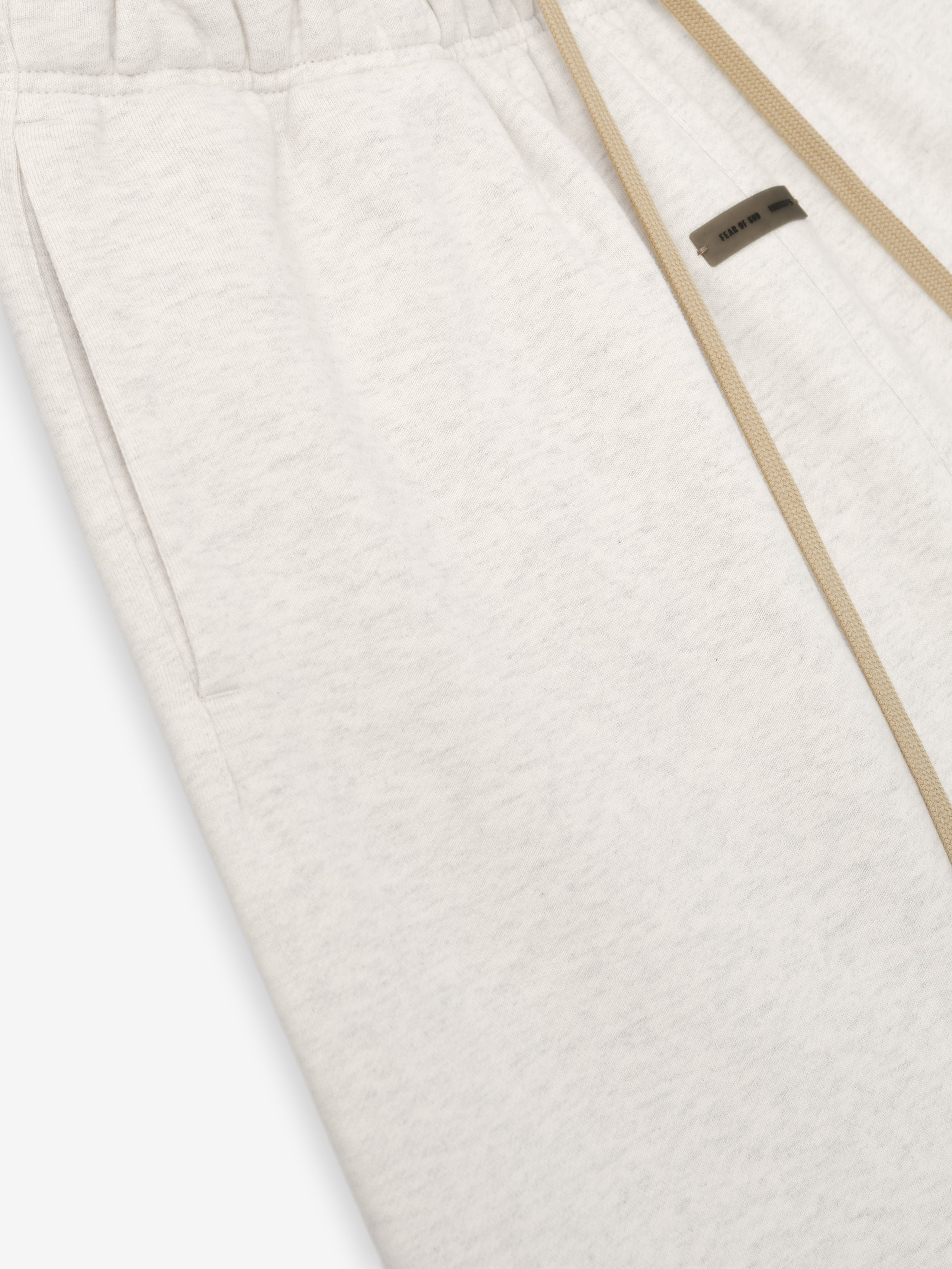 Close-up of oatmeal heather Womens Classic Sweatpant showing elastic waistband, side pocket, and beige drawstring detail.