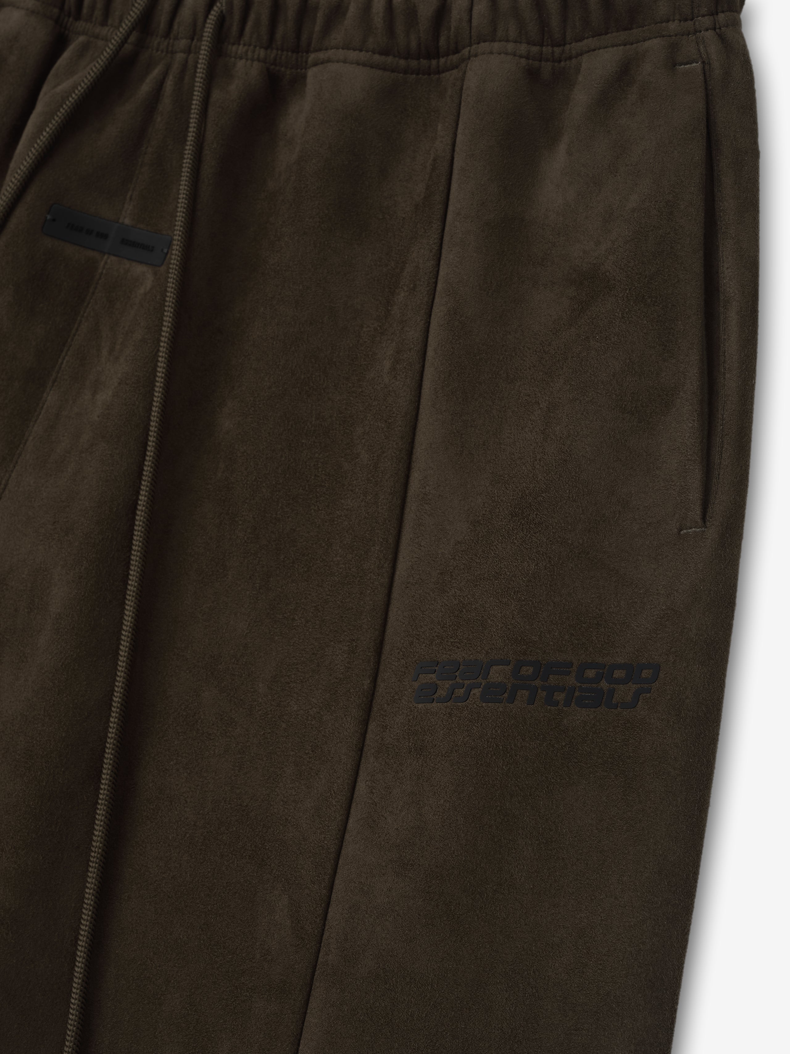 Close-up of brown Suede Fleece Flare Pant showing elastic waistband, drawstring, side pocket, and subtle logo detail