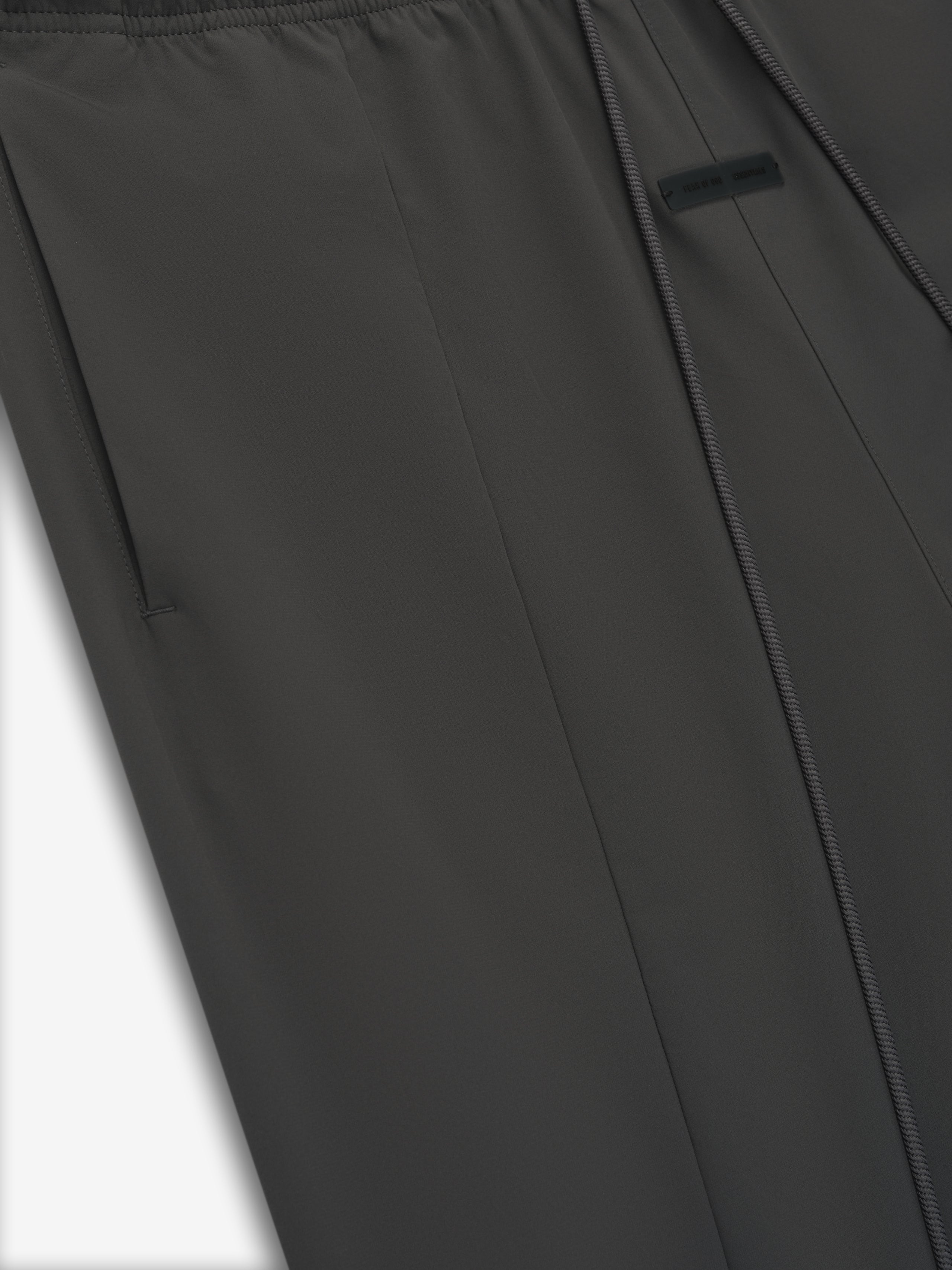 Close-up of iron grey Tech Nylon Relaxed Track Pant showing smooth fabric, side pocket, and subtle seam detail