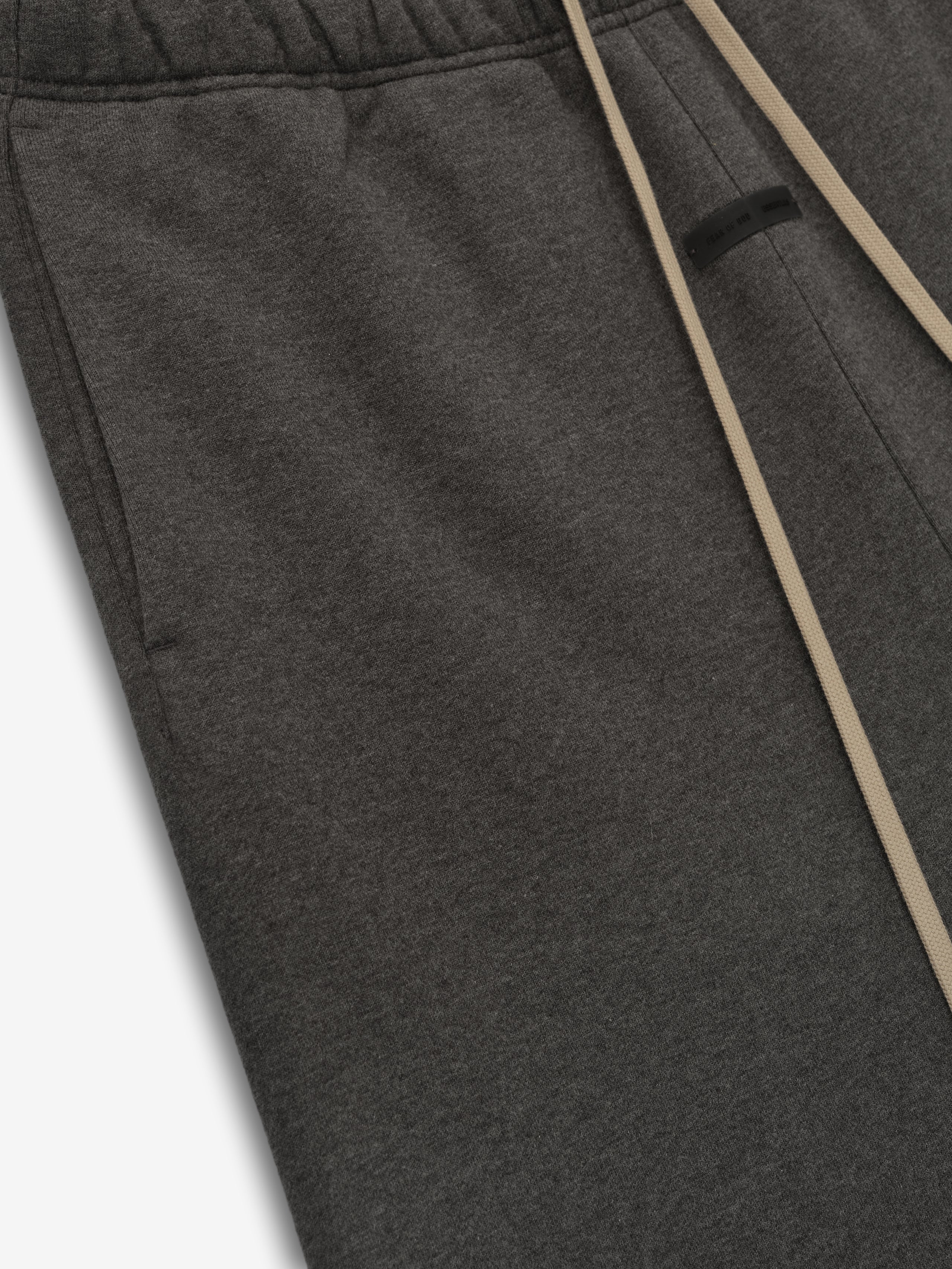 Close-up of charcoal heather Classic Sweatpant featuring elastic waistband and beige drawstrings on soft fabric texture