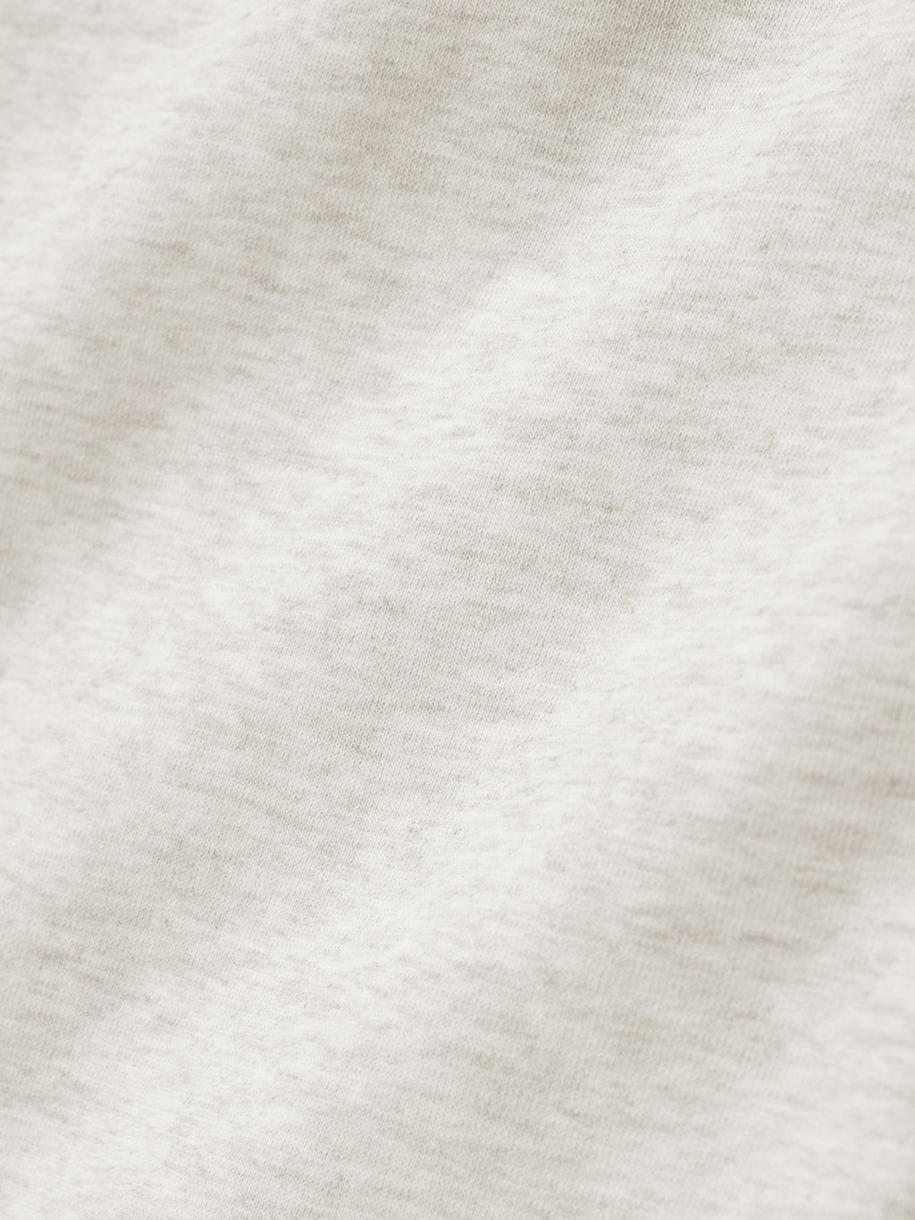 close-up of off-white heavyweight cotton fleece fabric showing soft texture and subtle knit detail