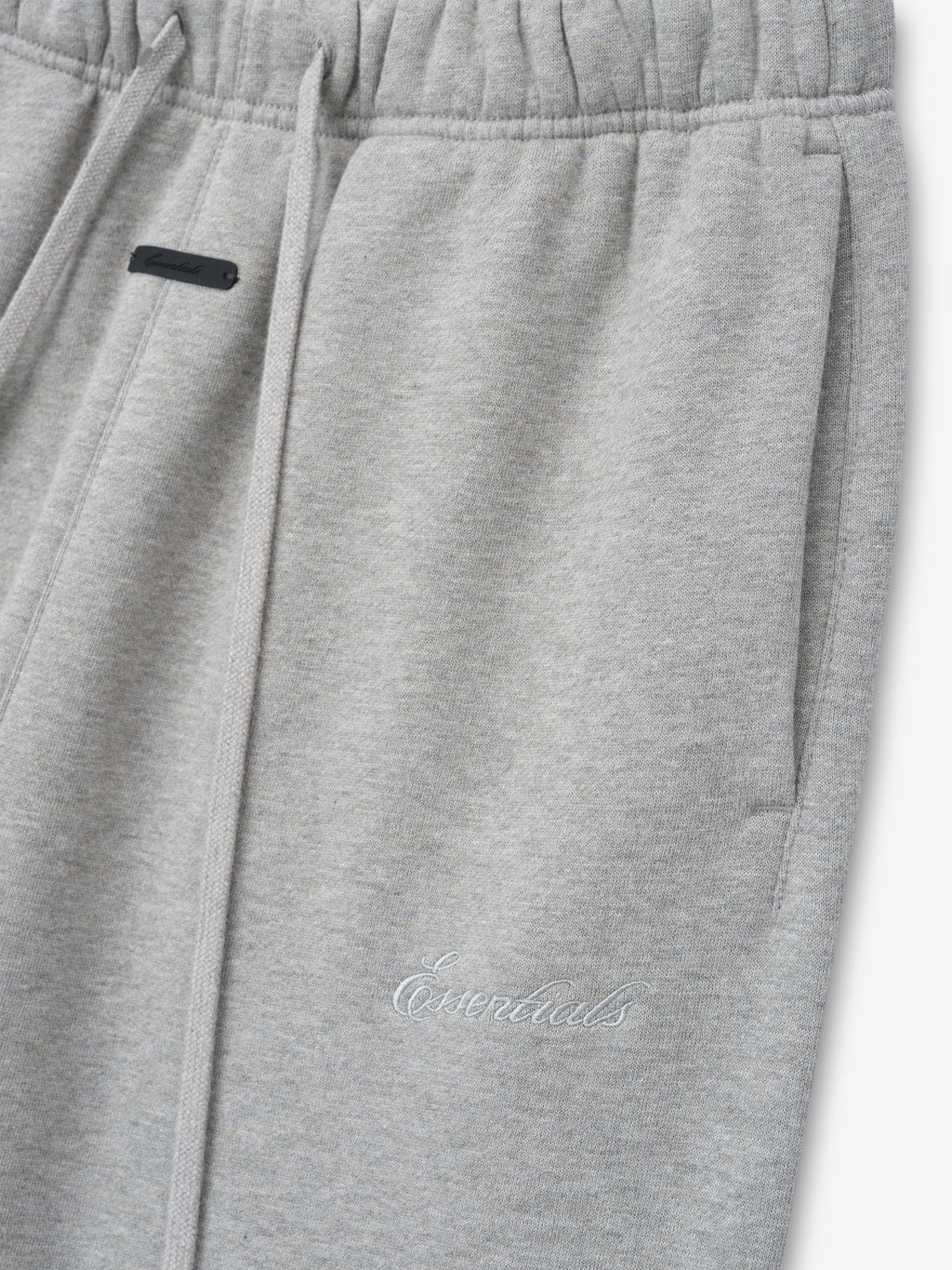 light gray women's classic flare sweatpants made from thick core fleece with elastic waistband and embroidered Essentials logo