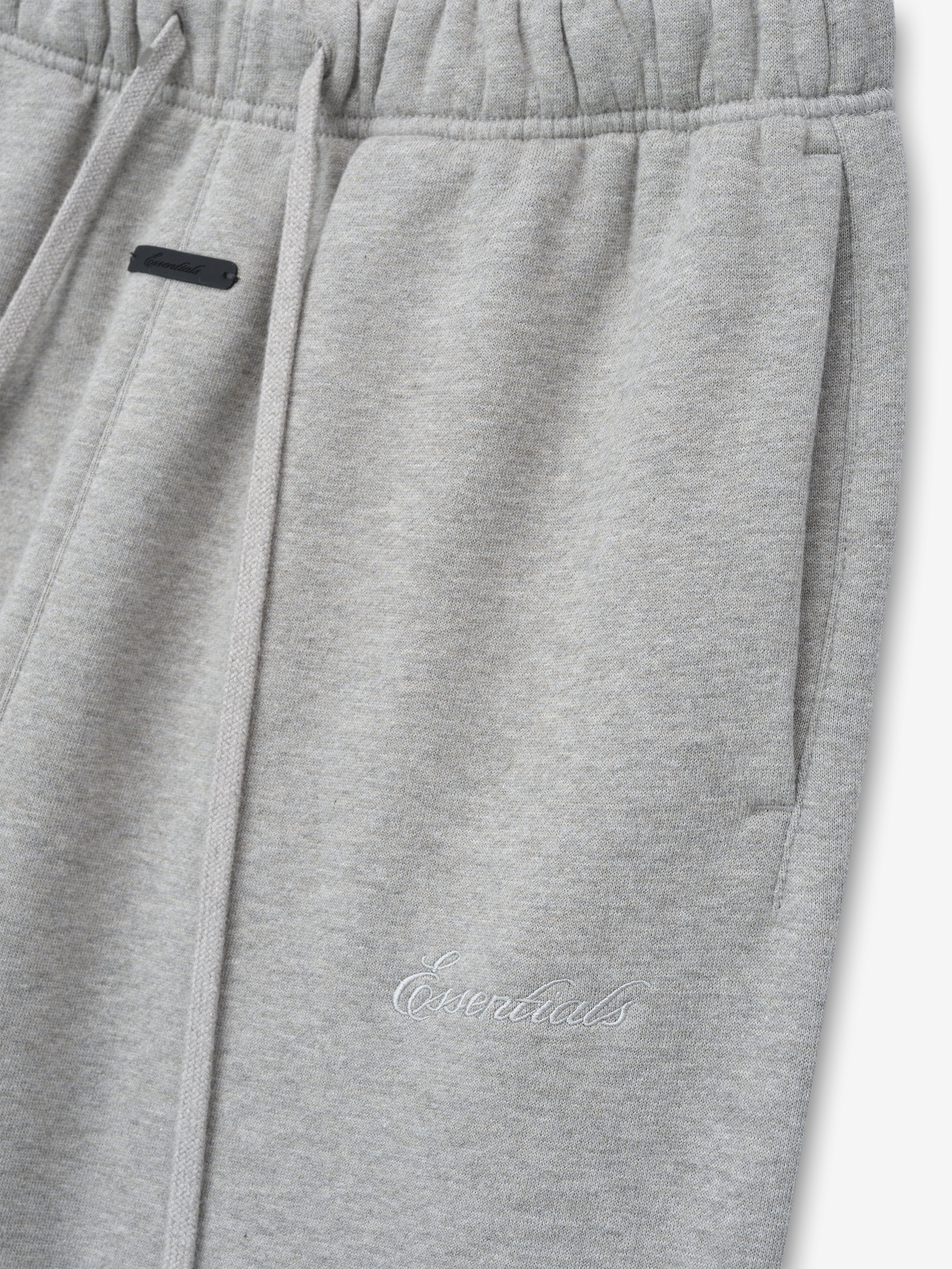 light gray women's classic flare sweatpants made from thick core fleece with elastic waistband and embroidered Essentials logo