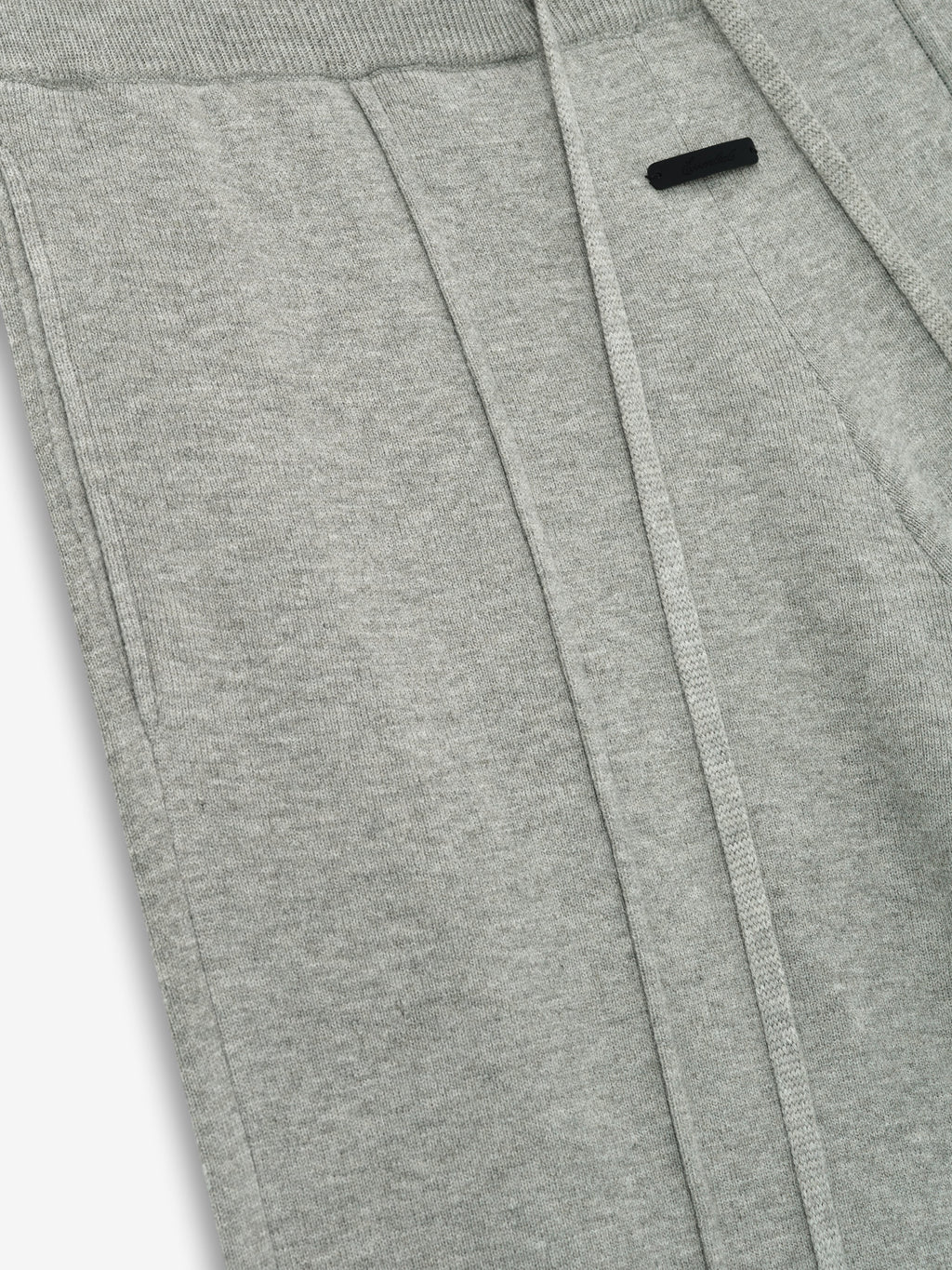 close-up of light grey women's lounge sweatpants in soft jersey knit with relaxed fit and subtle branding detail