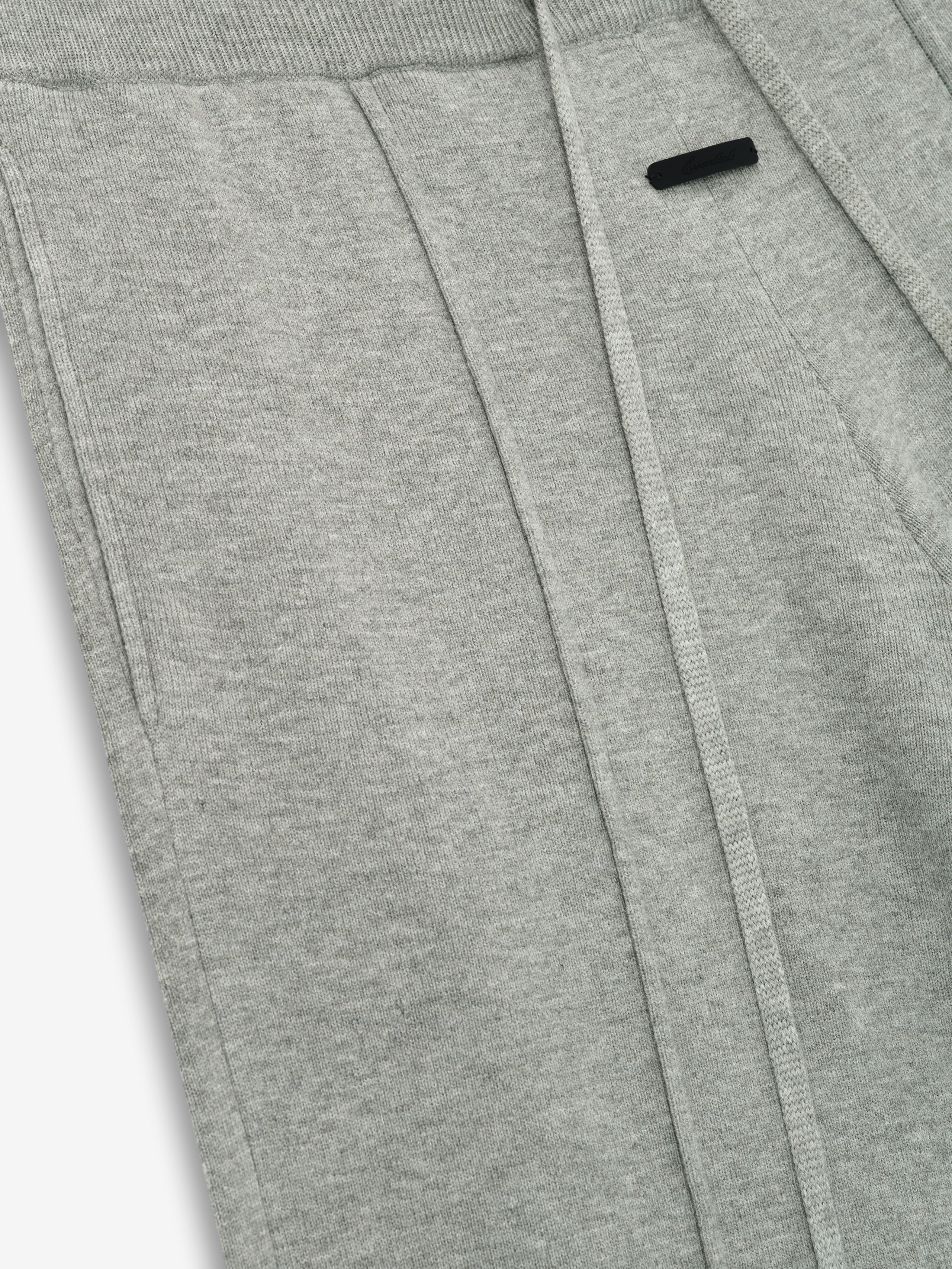 close-up of light grey women's lounge sweatpants in soft jersey knit with relaxed fit and subtle branding detail