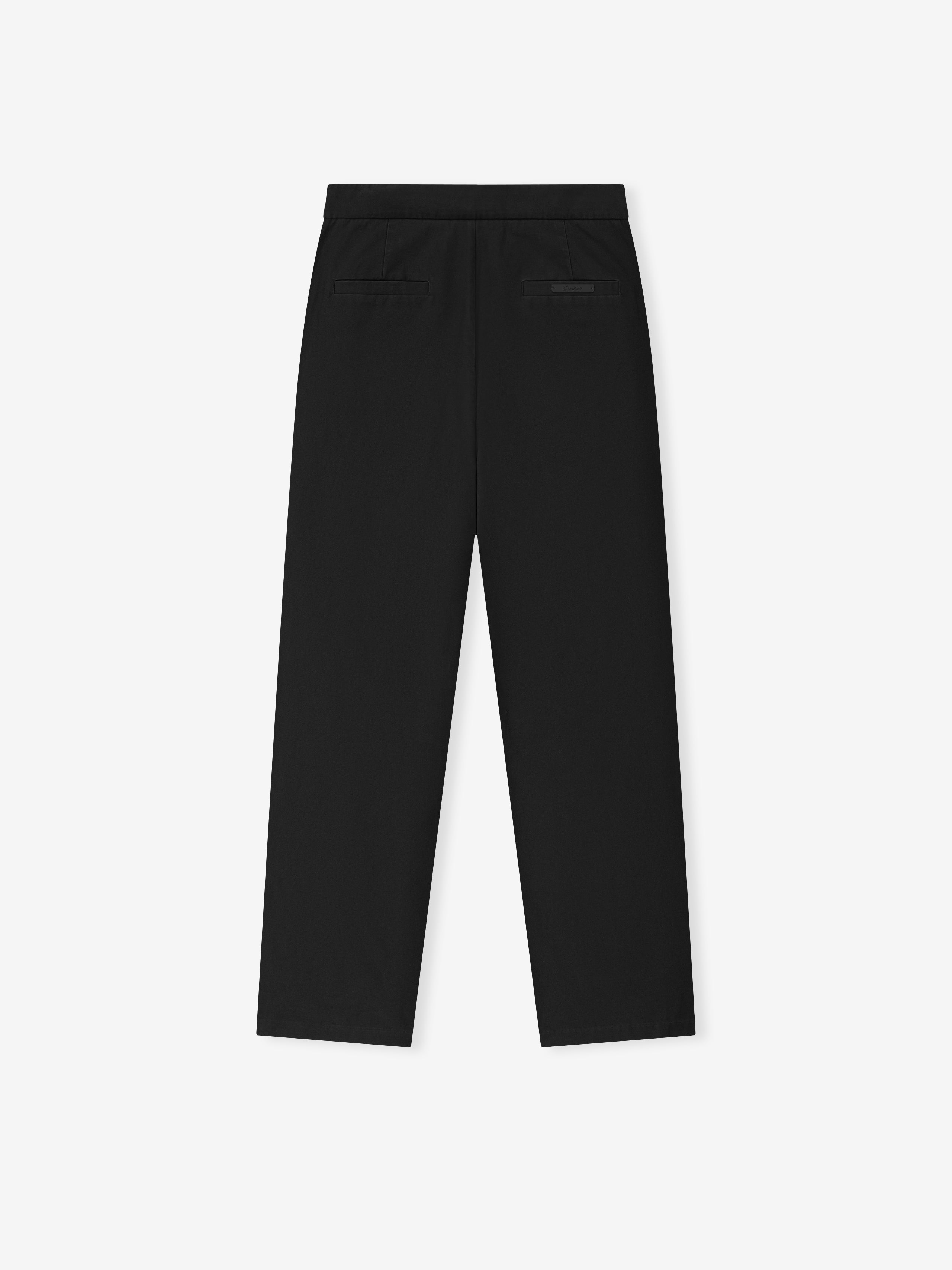 black cotton canvas pleat front pants with relaxed leg fit, back welt pockets, and elastic waistband