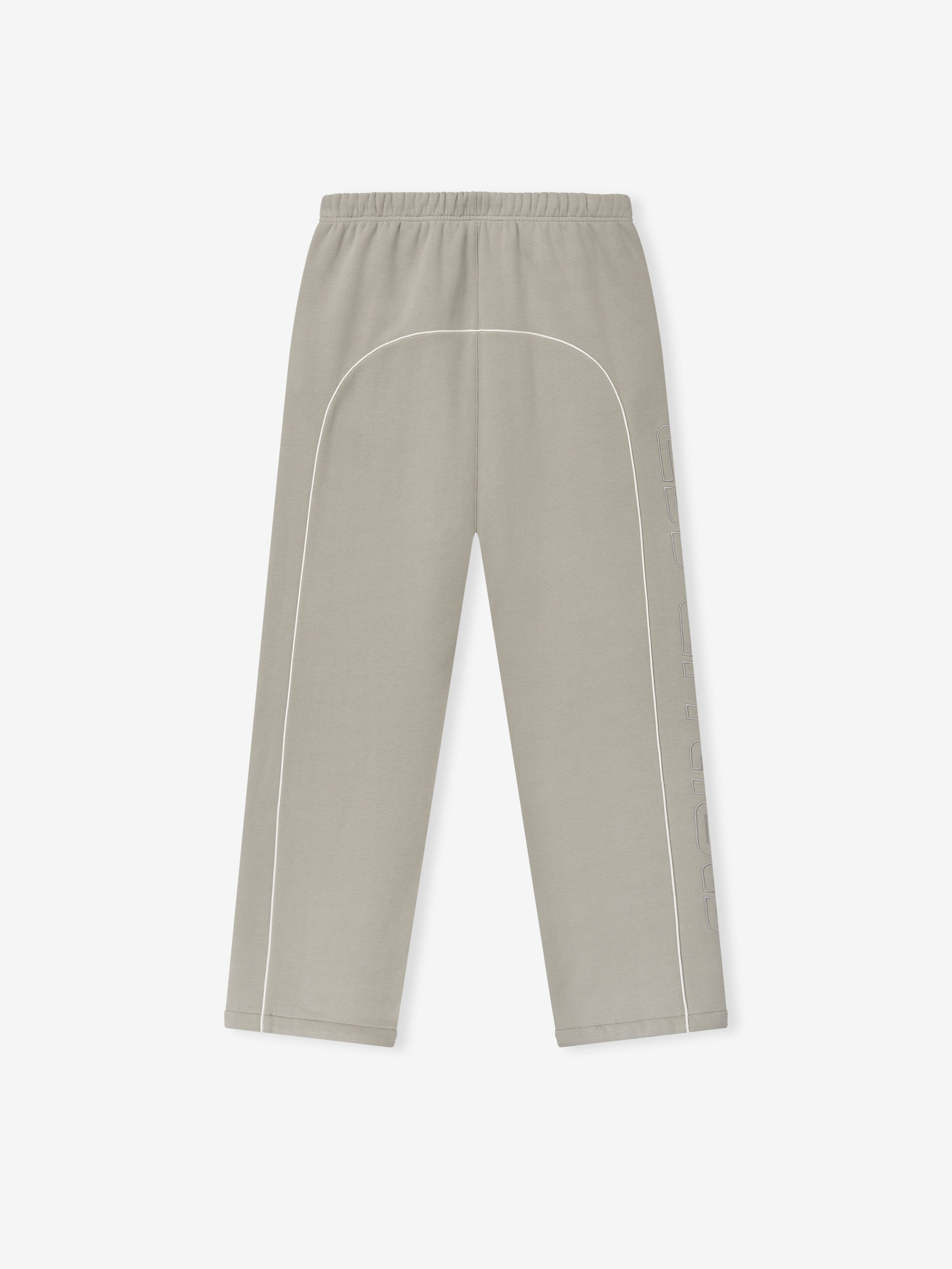 light taupe baggy sweatpants with elastic waistband, white sportswear piping, and tonal embroidered logo on side leg