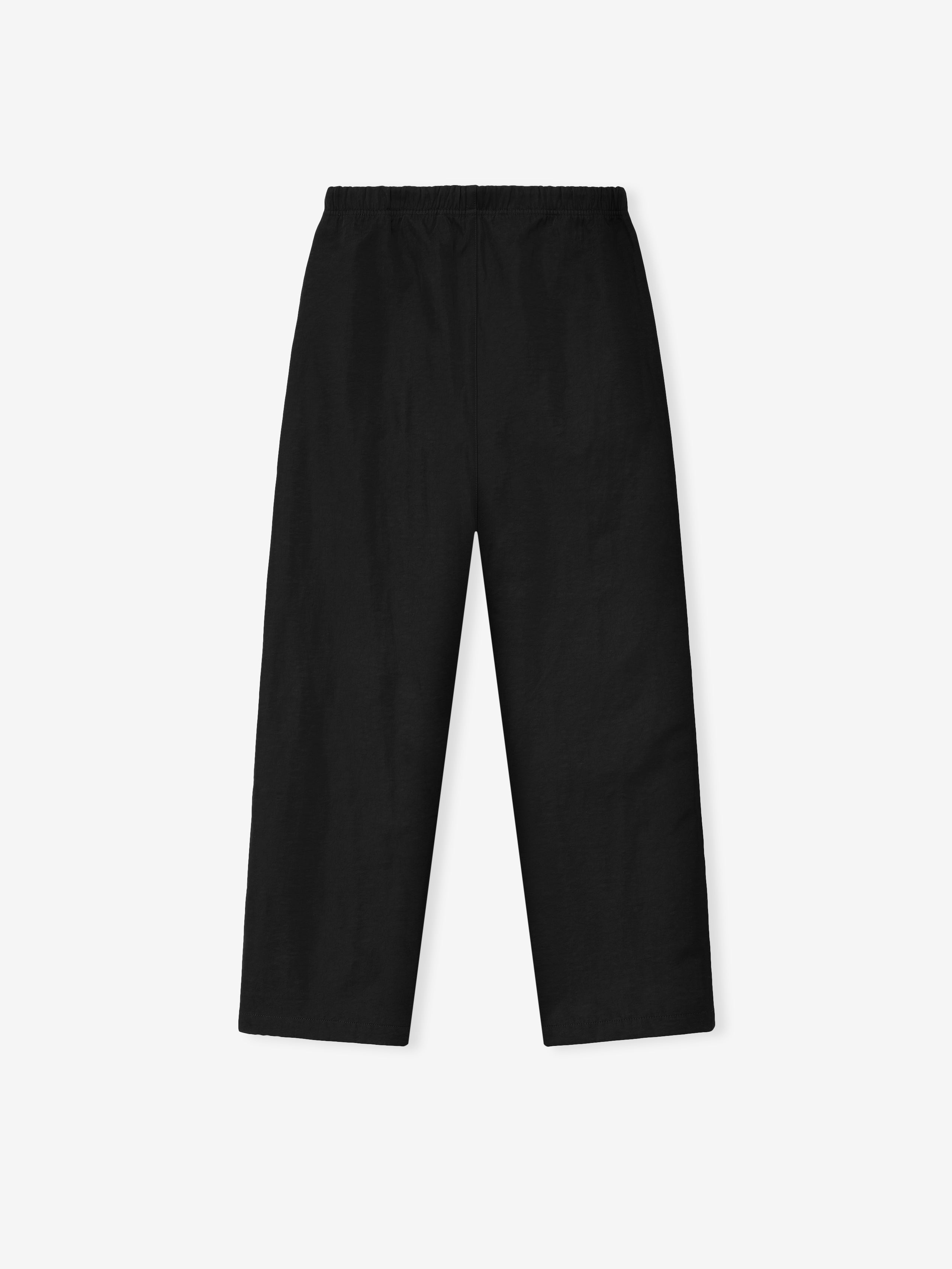 Black straight-leg pants with elastic waistband laid flat on a plain light background
