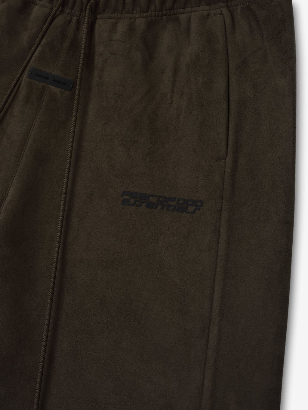 Close-up of brown Suede Fleece Relaxed Short showing elastic waistband, side pocket, and subtle tonal logo print