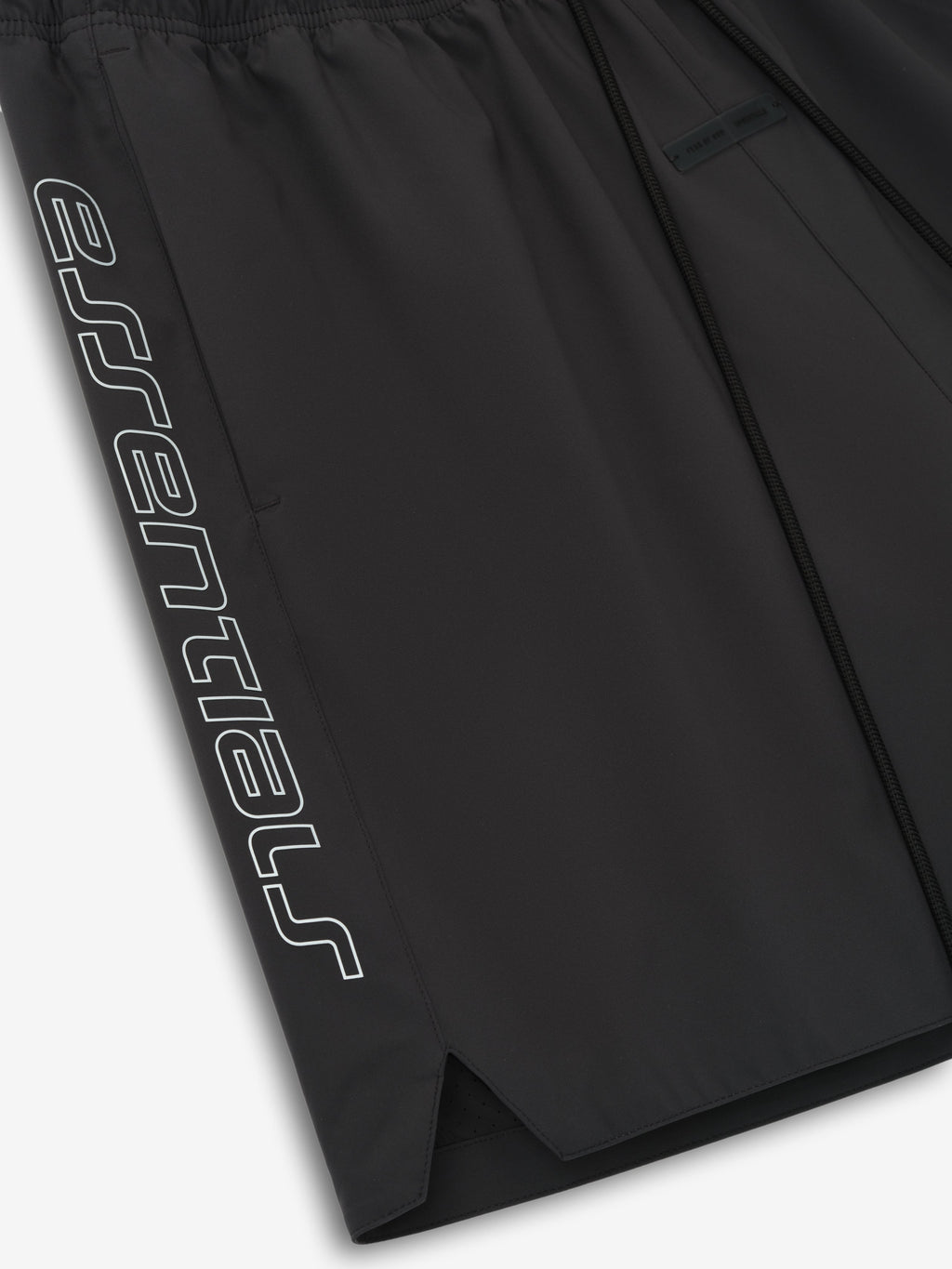 Close-up of vintage black Tech Nylon Classic Short showing tonal "essential" print on side and split hem detail