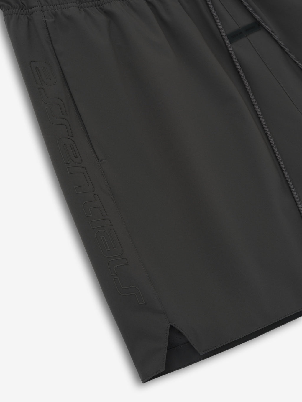 Close-up of iron grey Tech Nylon Classic Short showing embossed logo on side and elastic waistband detail
