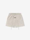 light beige core fleece sweatshort with elastic waist, long drawstrings, side pockets, and subtle Essentials logo on thigh