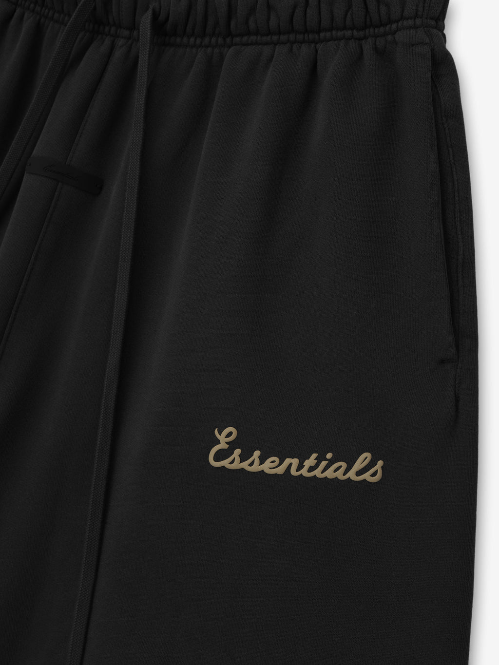 Black pants with 'essentials' puff print on a white background