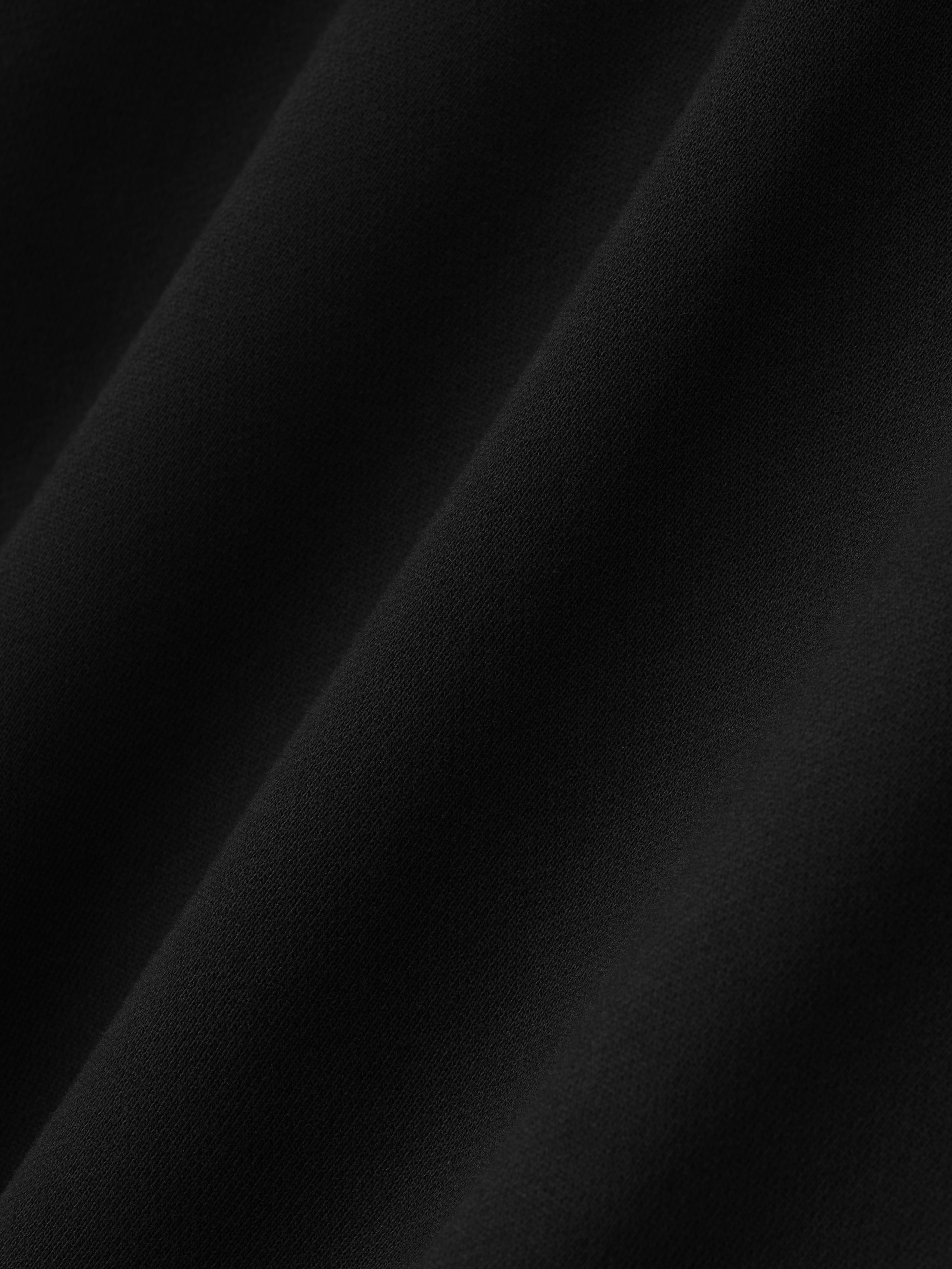 Close-up of smooth black fabric texture on Berlin 90's Hoodie showing soft material detail, gallery position 0