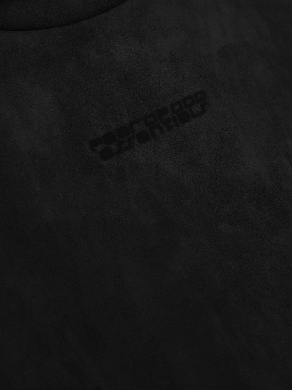 Close-up of vintage black suede fleece fabric with subtle embossed logo detail, file 192HO256941F_MODERN_HOODIE-VINTAGE_BLACK_3.jpg