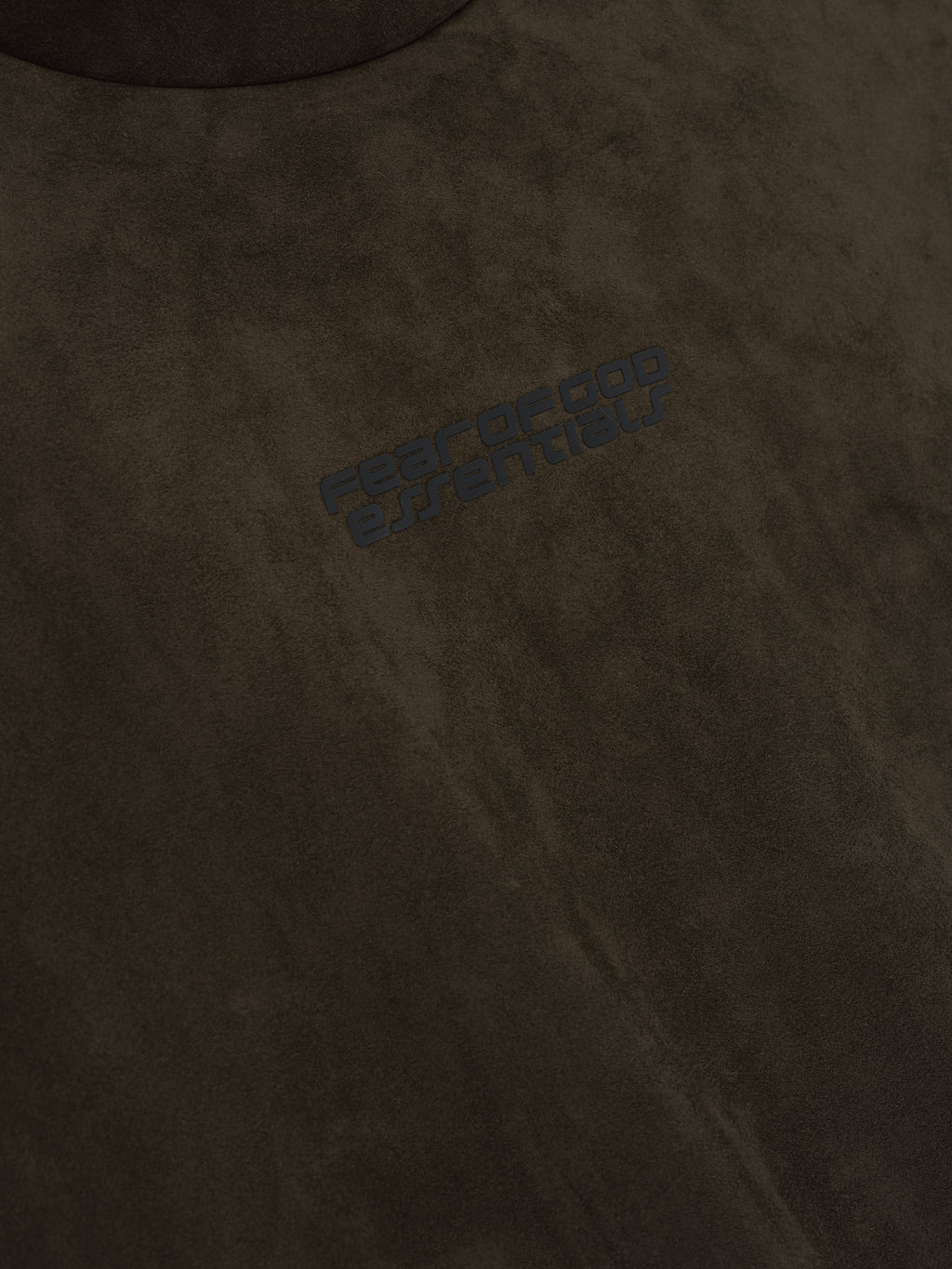 Close-up of brown suede fleece fabric with subtle black Fear of God Essentials logo, file 192HO256943F_MODERN_HOODIE-BROWN_3.jpg