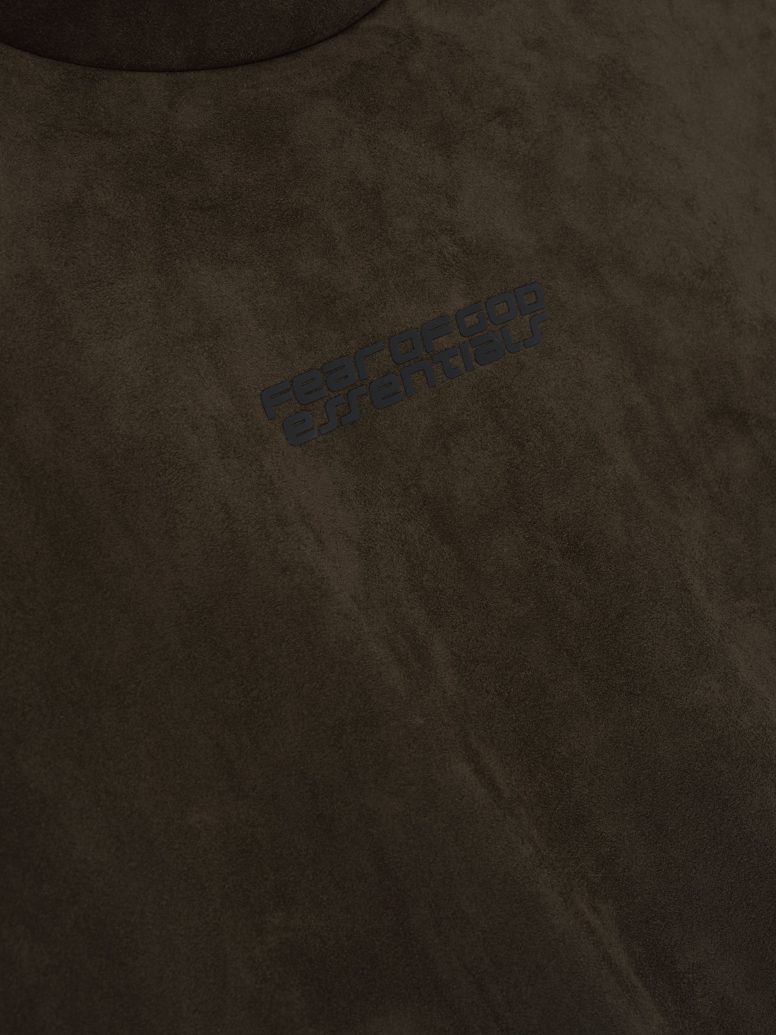 Close-up of brown suede fleece fabric with subtle black Fear of God Essentials logo, file 192HO256943F_MODERN_HOODIE-BROWN_3.jpg
