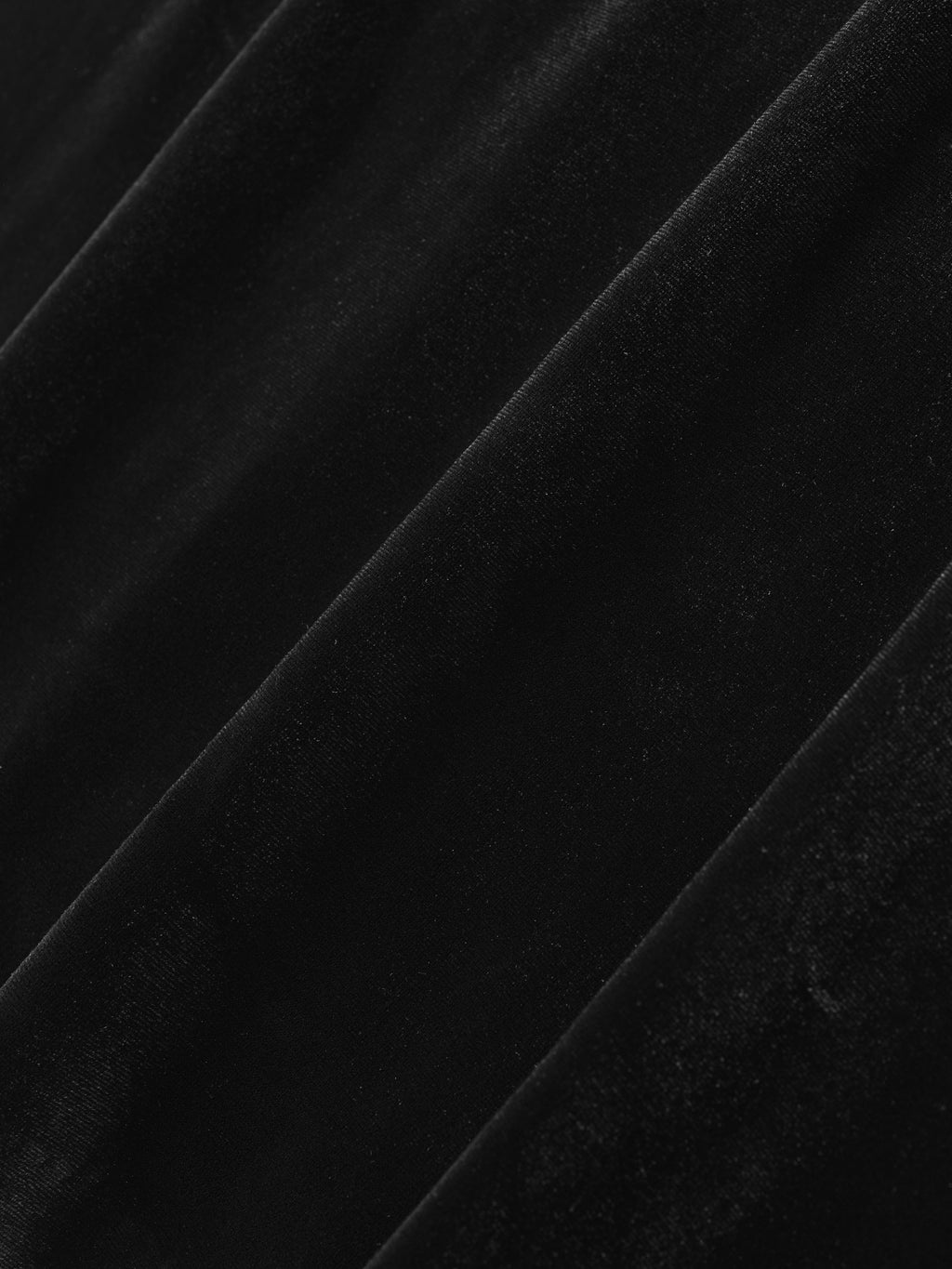 close-up of black high shine velour fabric with soft plush texture and subtle diagonal folds