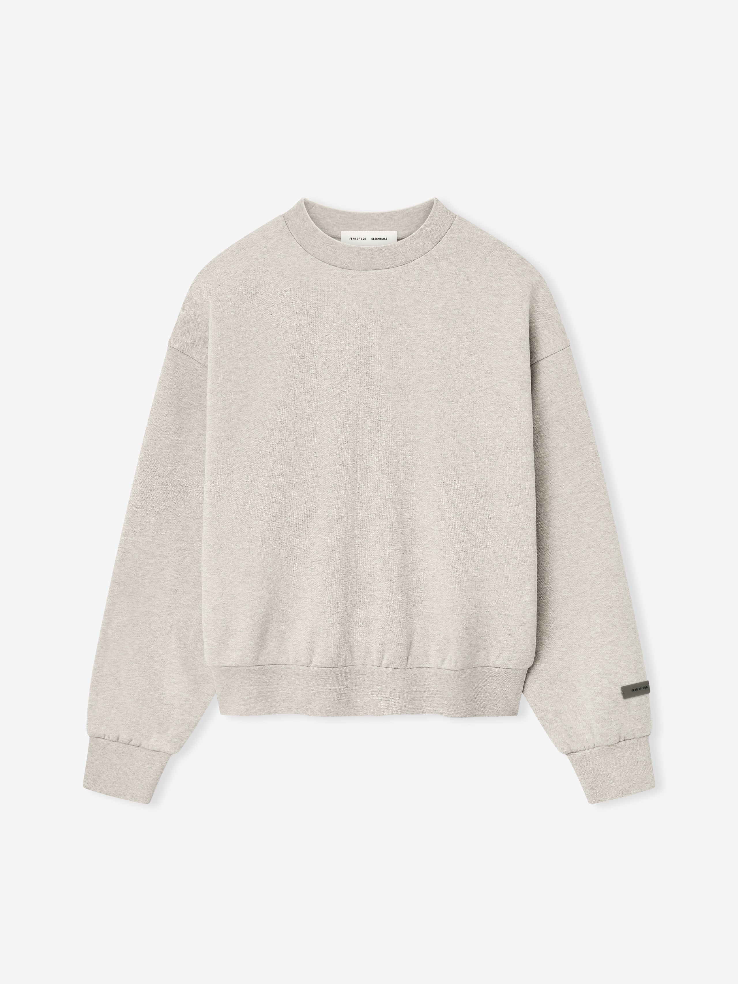 Heather stone Classic Fleece Crewneck laid flat with ribbed cuffs and hem, showing minimalistic tag detail on sleeve.