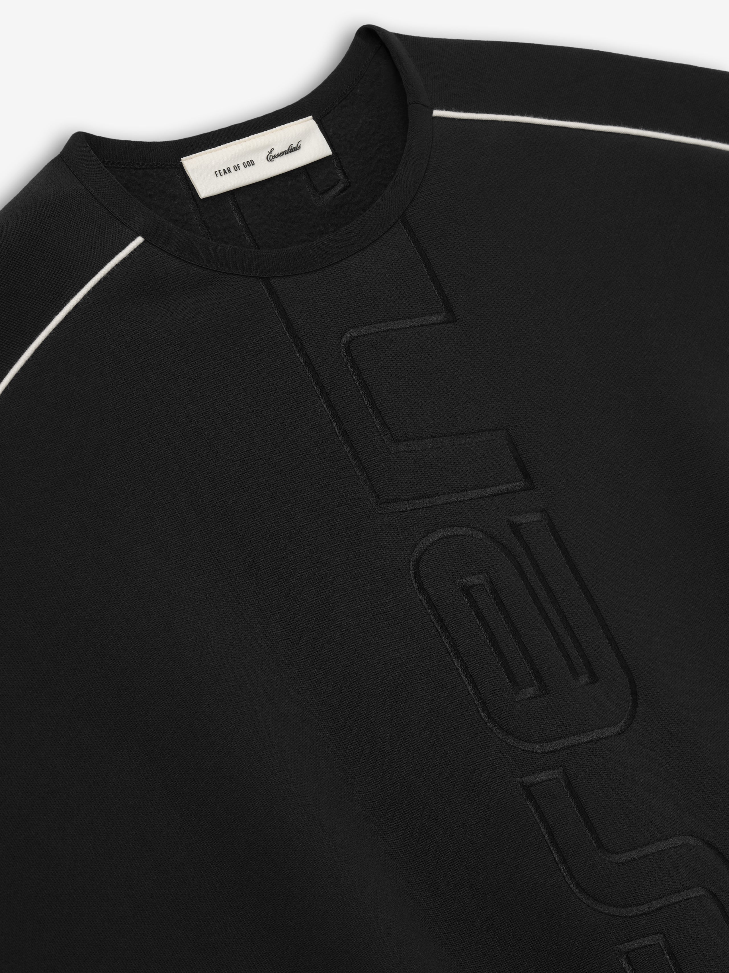 black crewneck sweatshirt with relaxed wide fit and subtle embossed vertical logo and white piping on shoulders
