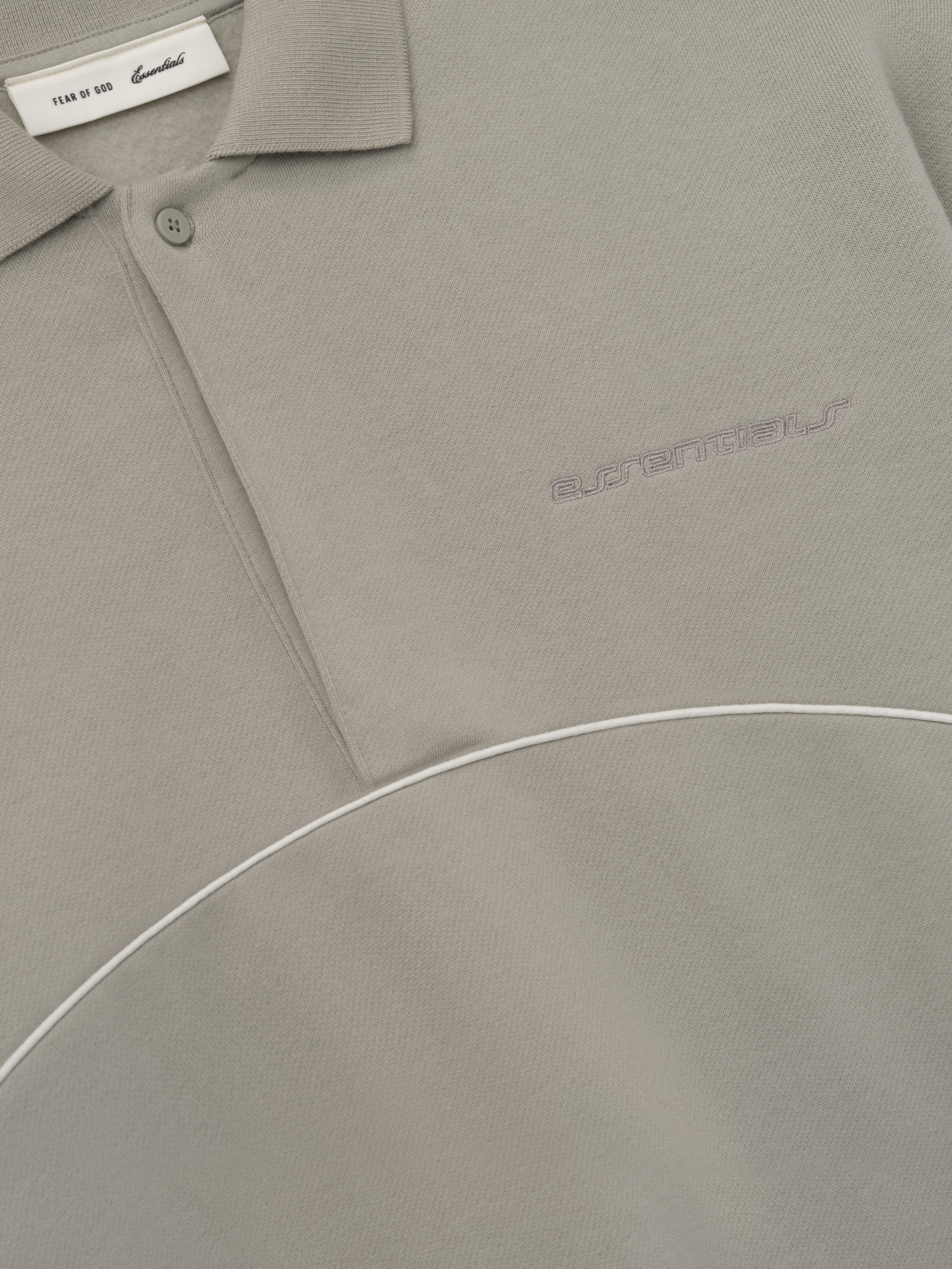 taupe modern polo sweatshirt with volume fit, cropped silhouette, embroidered logo, and curved white piping detail across chest