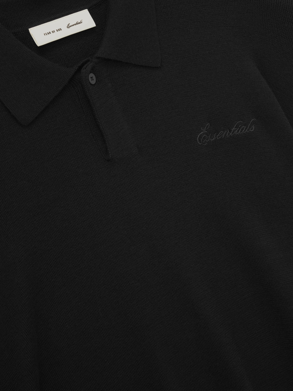 Black polo shirt with 'Essentials' embroidery