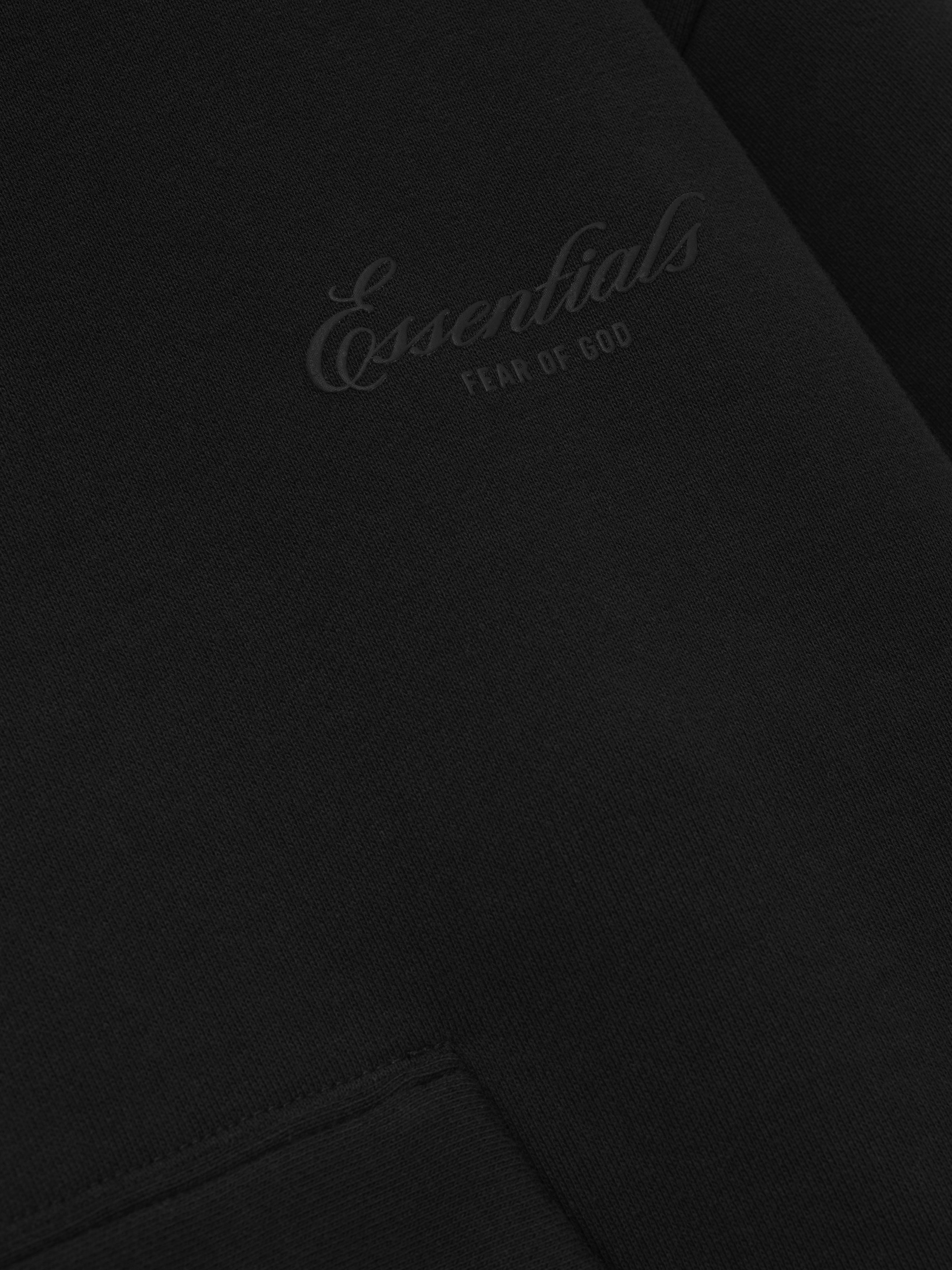 Black sweatshirt with 'Essentials' logo on a black background