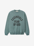 front view of faded teal pigment-dyed crewneck sweatshirt with black Essentials Fear of God logo and ribbed cuffs and hem