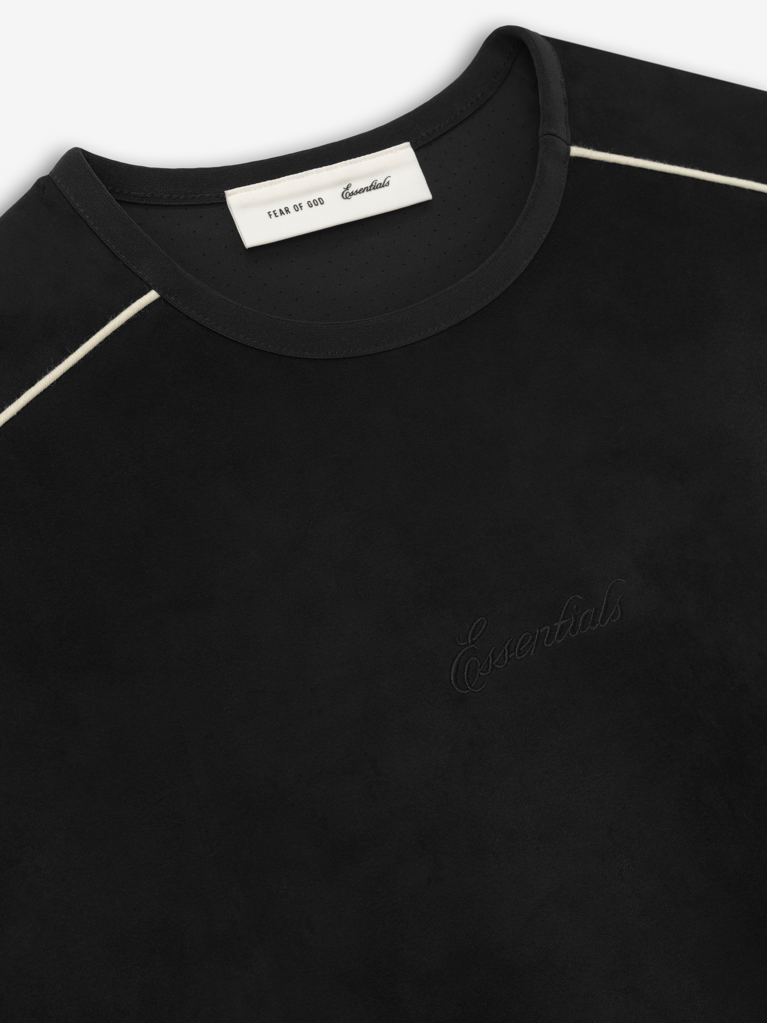 Black crewneck top with subtle embossed "Essentials" text on front and contrasting white piping along shoulder seams