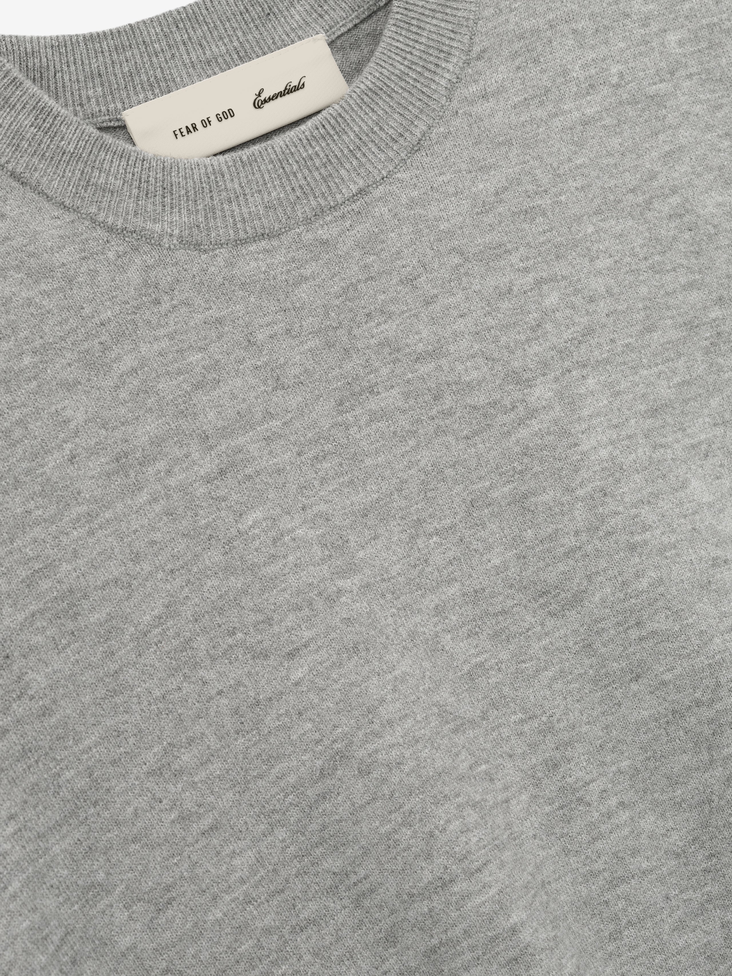 close-up of soft light grey knit fabric and crew neckline on women's fitted long sleeve knit tee
