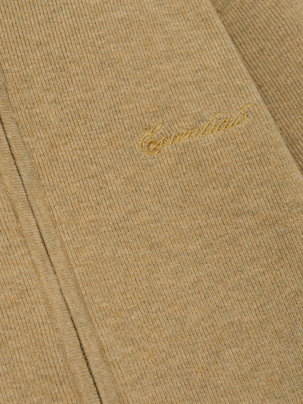 Beige fabric with gold embroidery on a matching beige background