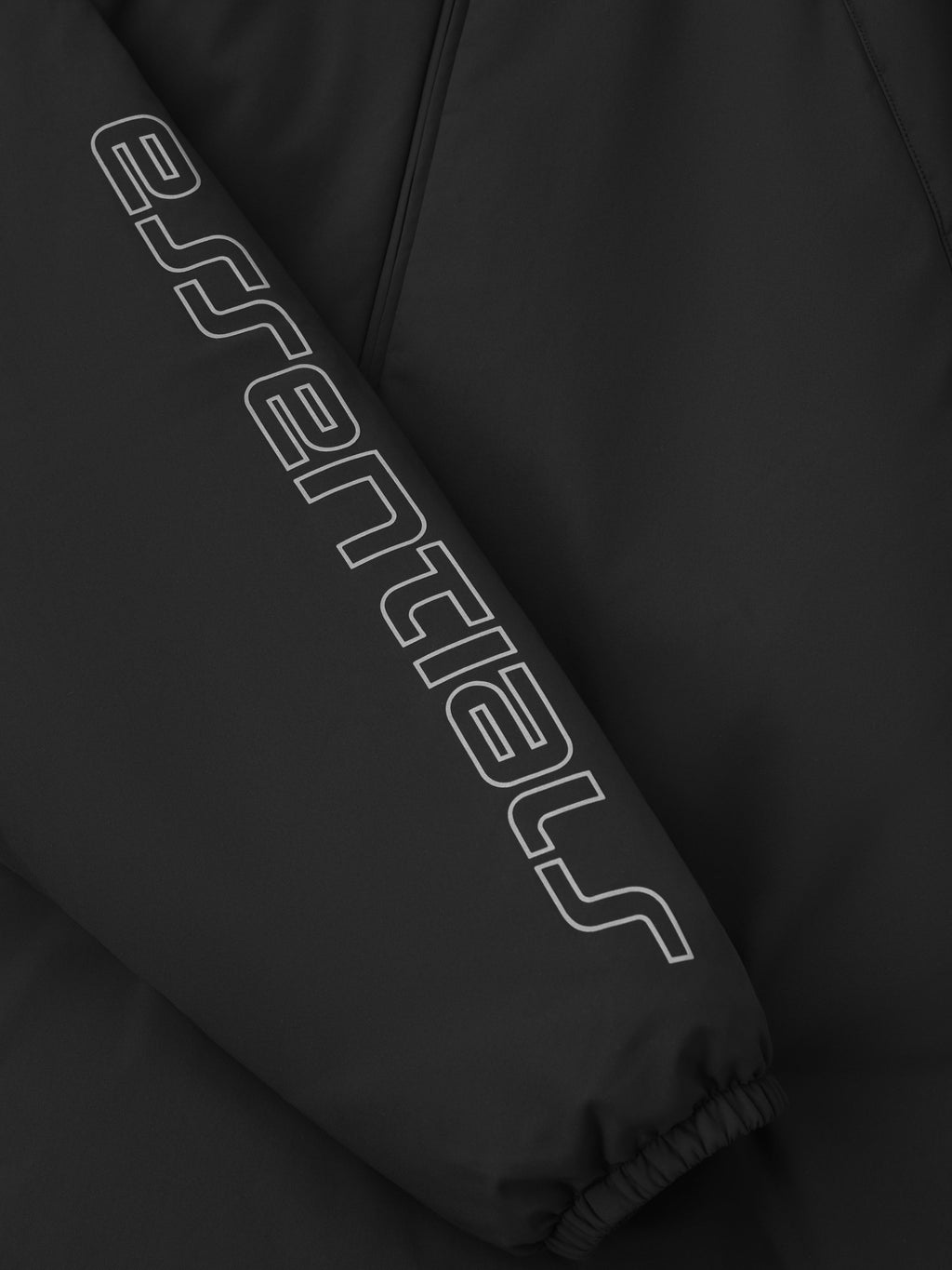 Close-up of vintage black Tech Nylon Half Zip Anorak sleeve featuring bold Essentials logo print and elastic cuff, gallery 0
