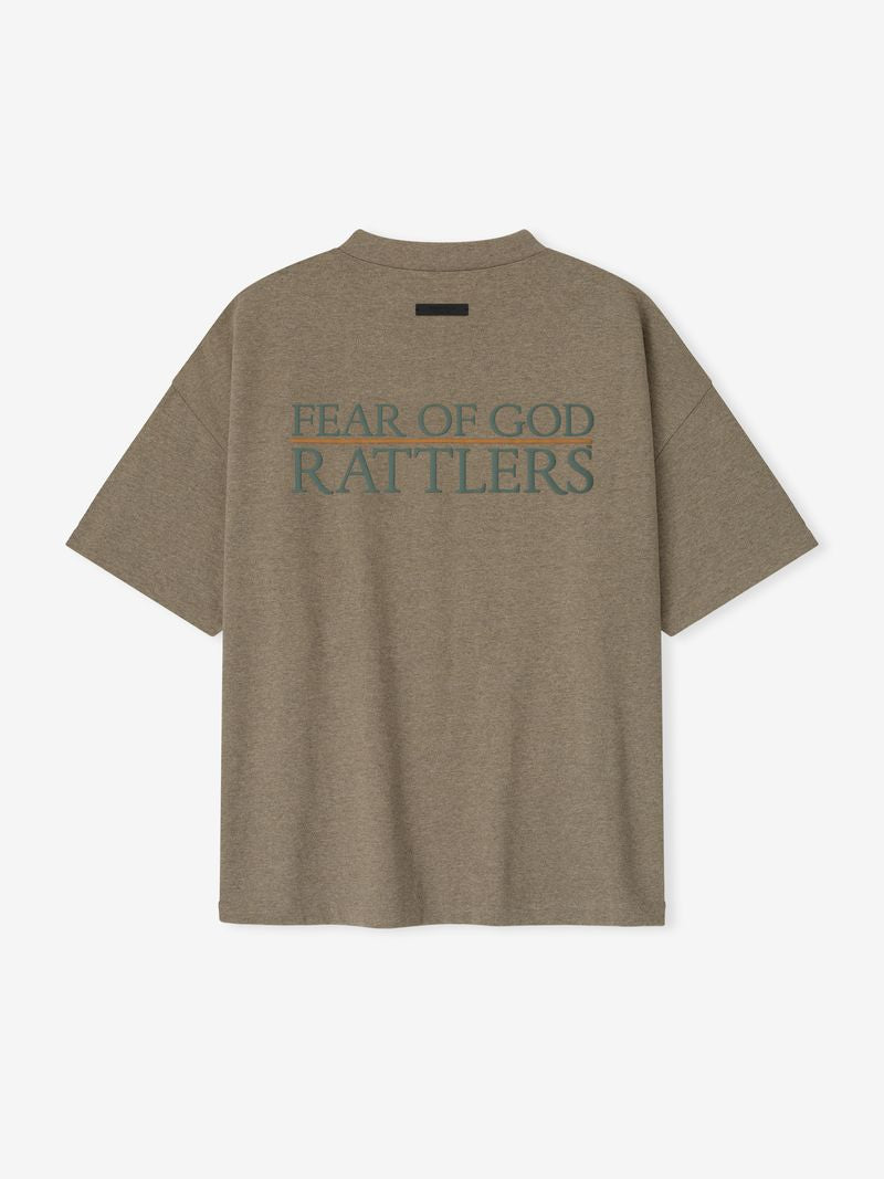 Rear view of brown FAMU 90s Tee featuring large teal "FEAR OF GOD RATTLERS" text and minimal black label above, file 3YwJGyfA.jpg
