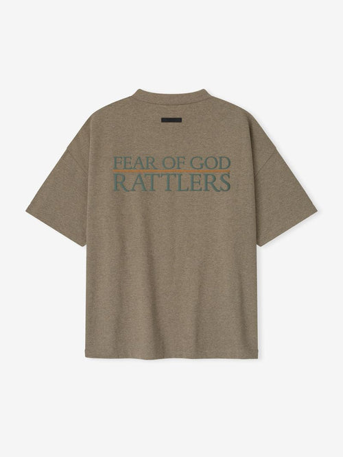 Rear view of brown FAMU 90s Tee featuring large teal "FEAR OF GOD RATTLERS" text and minimal black label above, file 3YwJGyfA.jpg