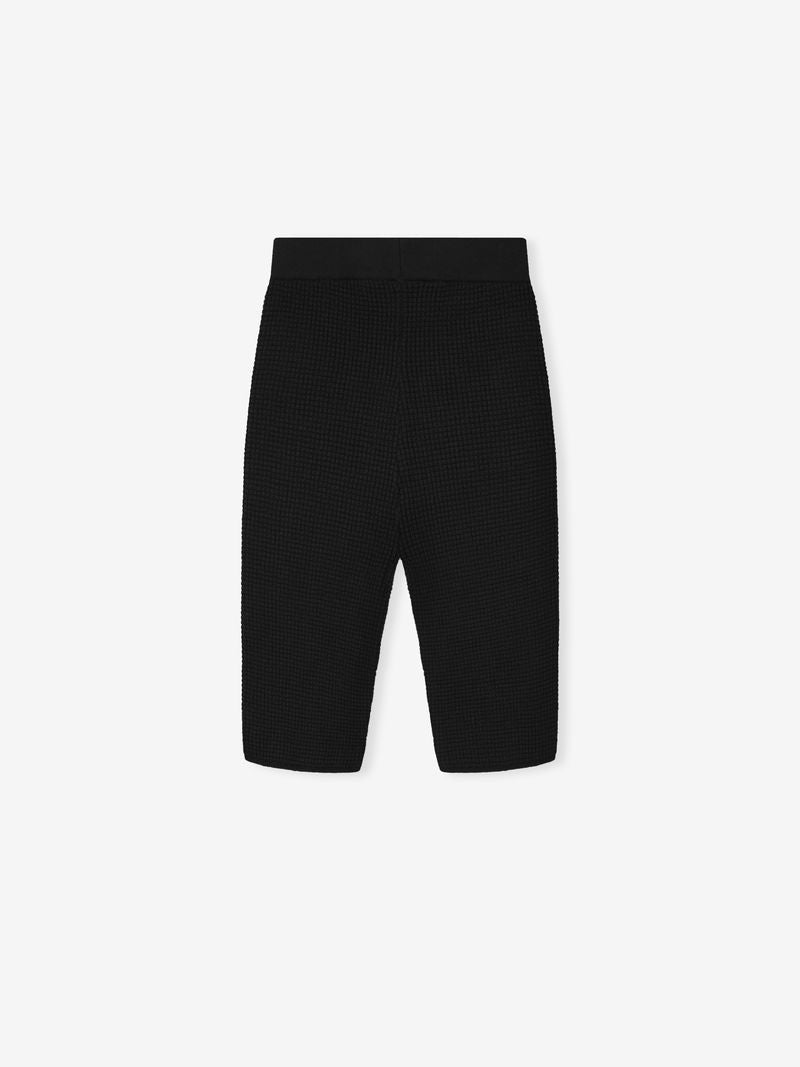 black textured waffle knit women's biker shorts with high elastic waistband laid flat on white background
