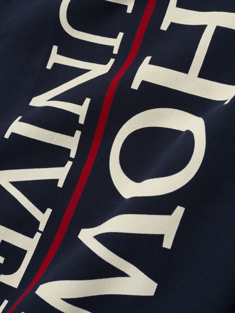 Close-up of navy Howard University Lounge Sweatpant showing large cream text and vertical red stripe detail, file 5ORFaU7w.jpg