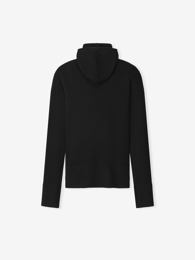 Back view of a plain black long sleeve hooded ribbed top for women on a white background