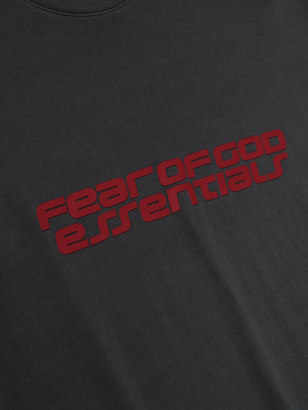 Close-up of iron grey Kids Classic Short Sleeve Tee with bold red Fear of God Essentials logo angled across chest, gallery 0