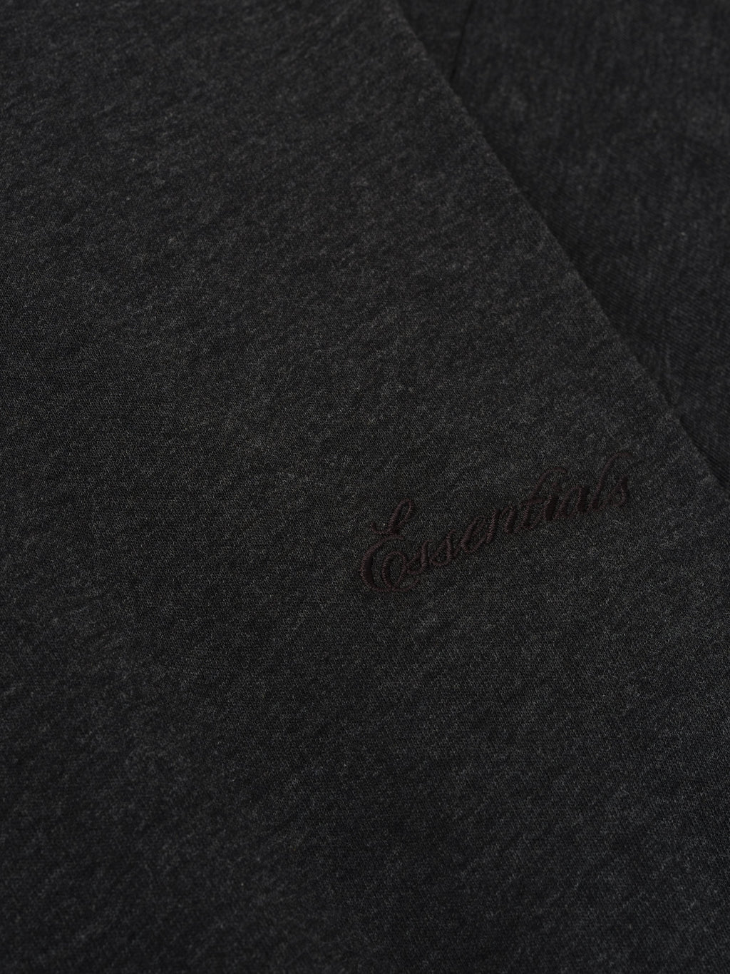 Close-up of vintage black Kids Embroidered Essential Tee showing tonal Essentials script embroidery on fabric, gallery position 0
